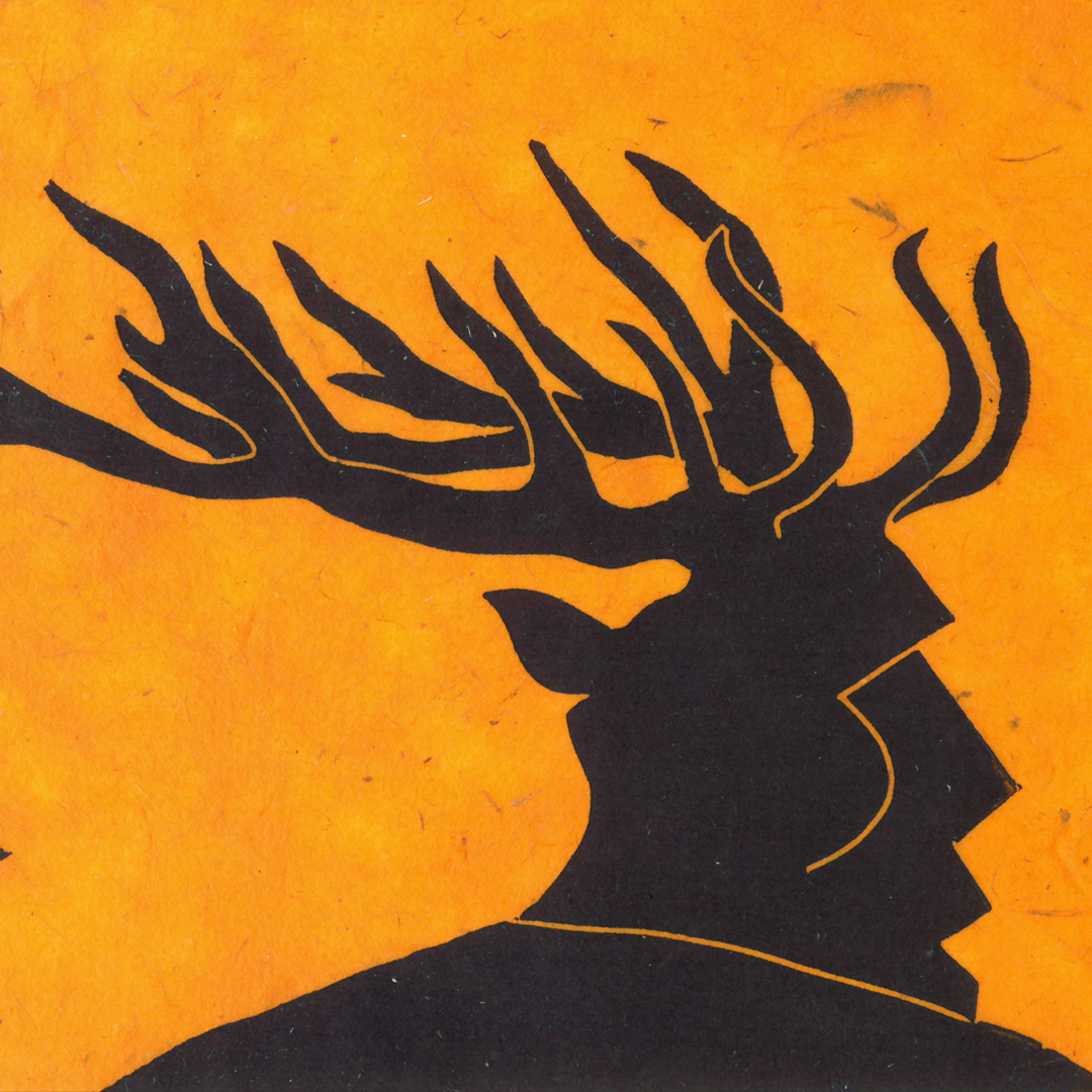 Silhouette of a reindeer with large antlers against an orange background.