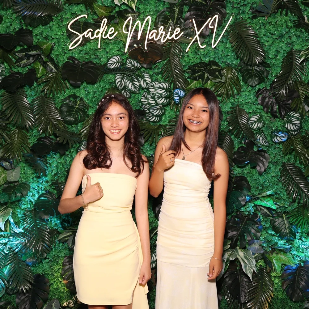 Guests posing in a studio-lit Luxelle booth portrait at a quinceañera