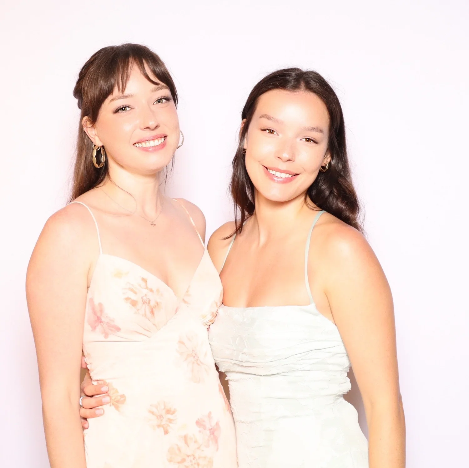 Studio-lit photo booth portrait of two wedding guests smiling side by side at an evening reception at Saddlerock Ranch, Malibu
