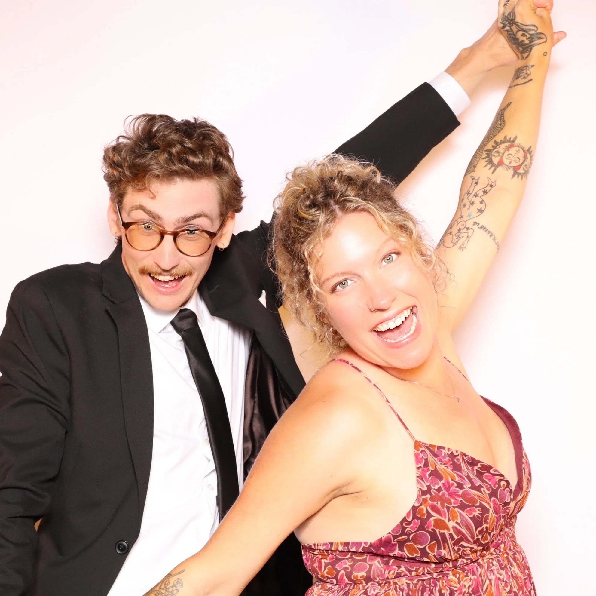 Wedding guests posing at the Luxelle photo booth during Julianna and Micah's reception