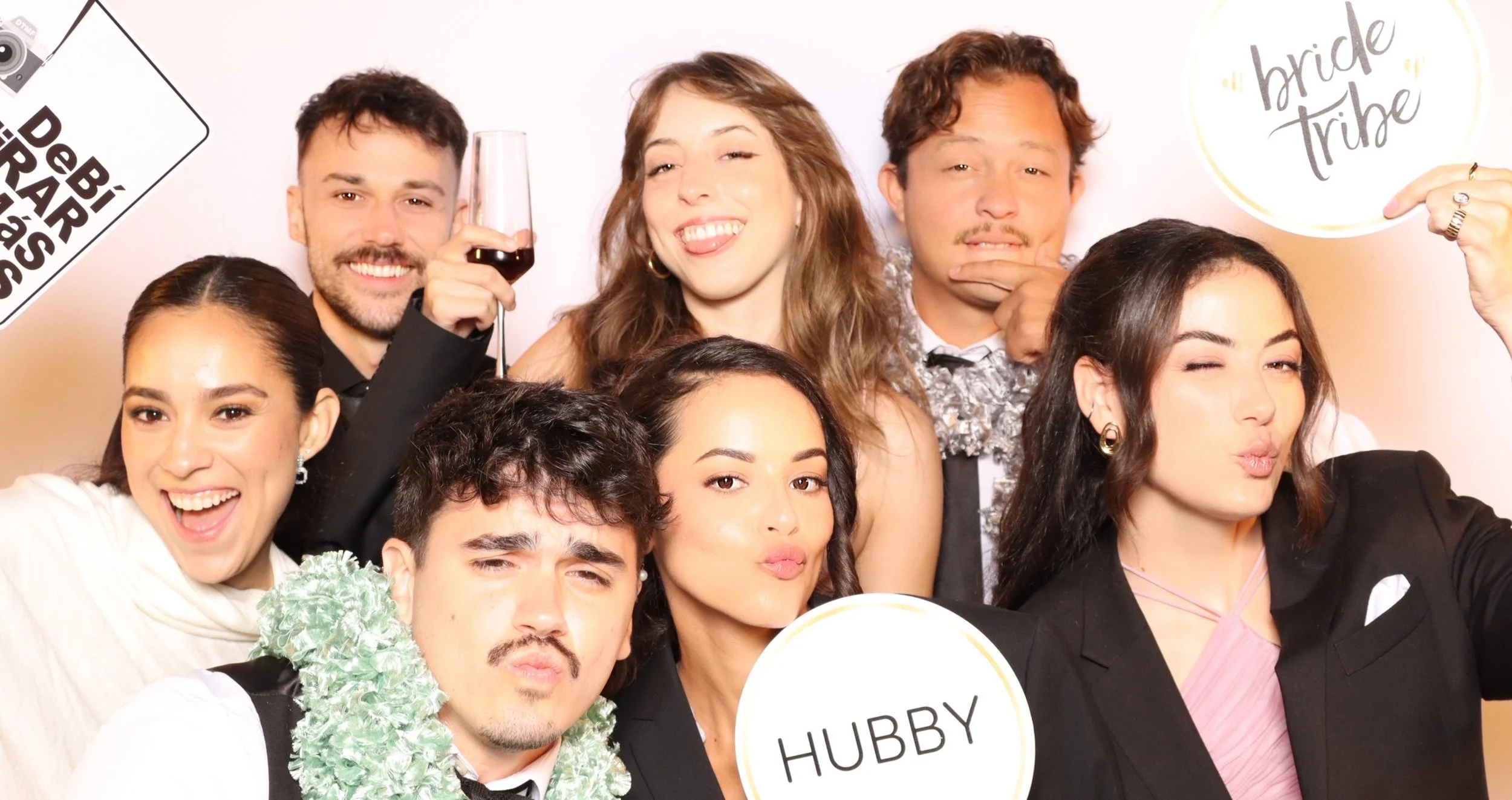Wedding guests posing at the Luxelle photo booth during Julianna and Micah's reception