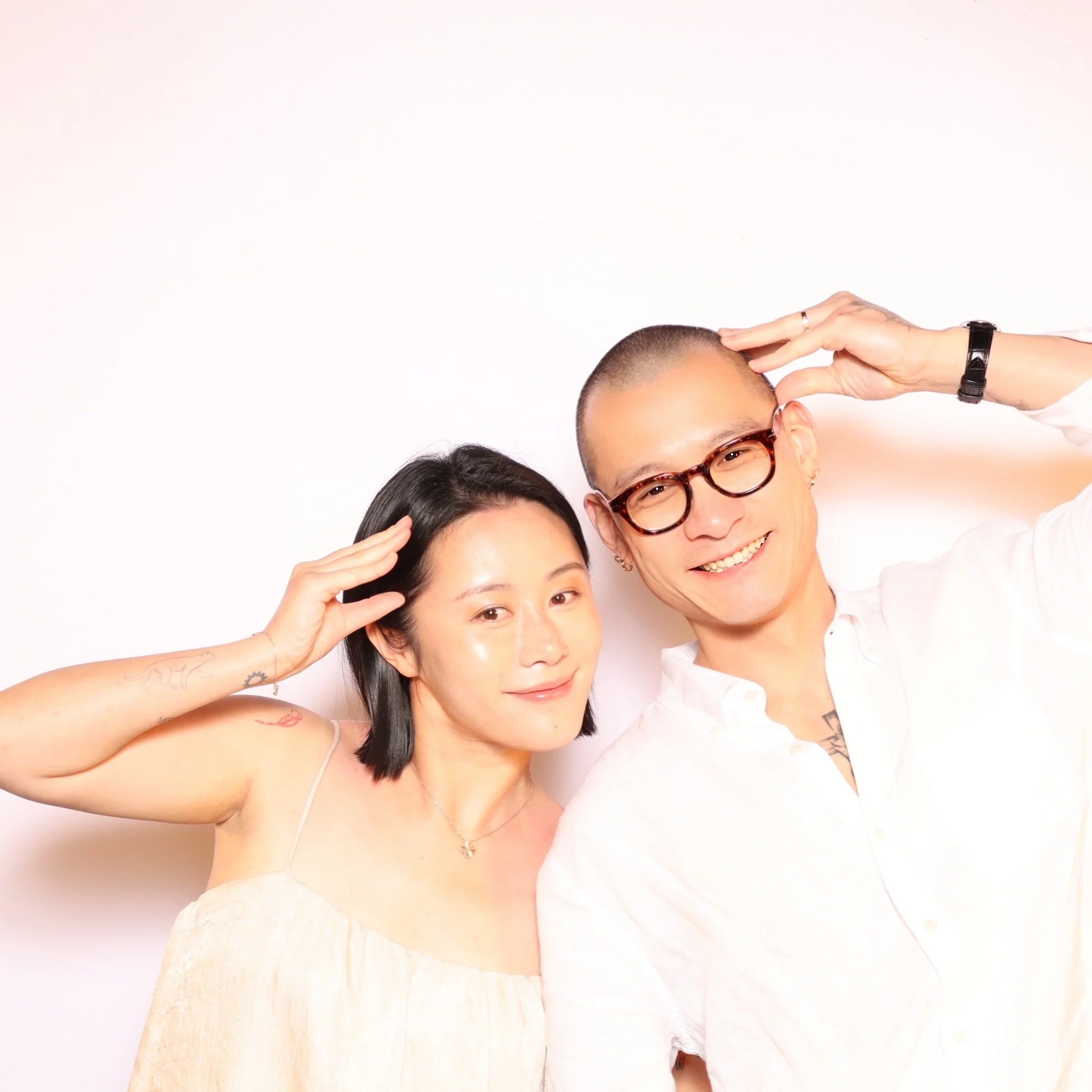 Wedding guests posing at the Luxelle photo booth during Julianna and Micah's reception
