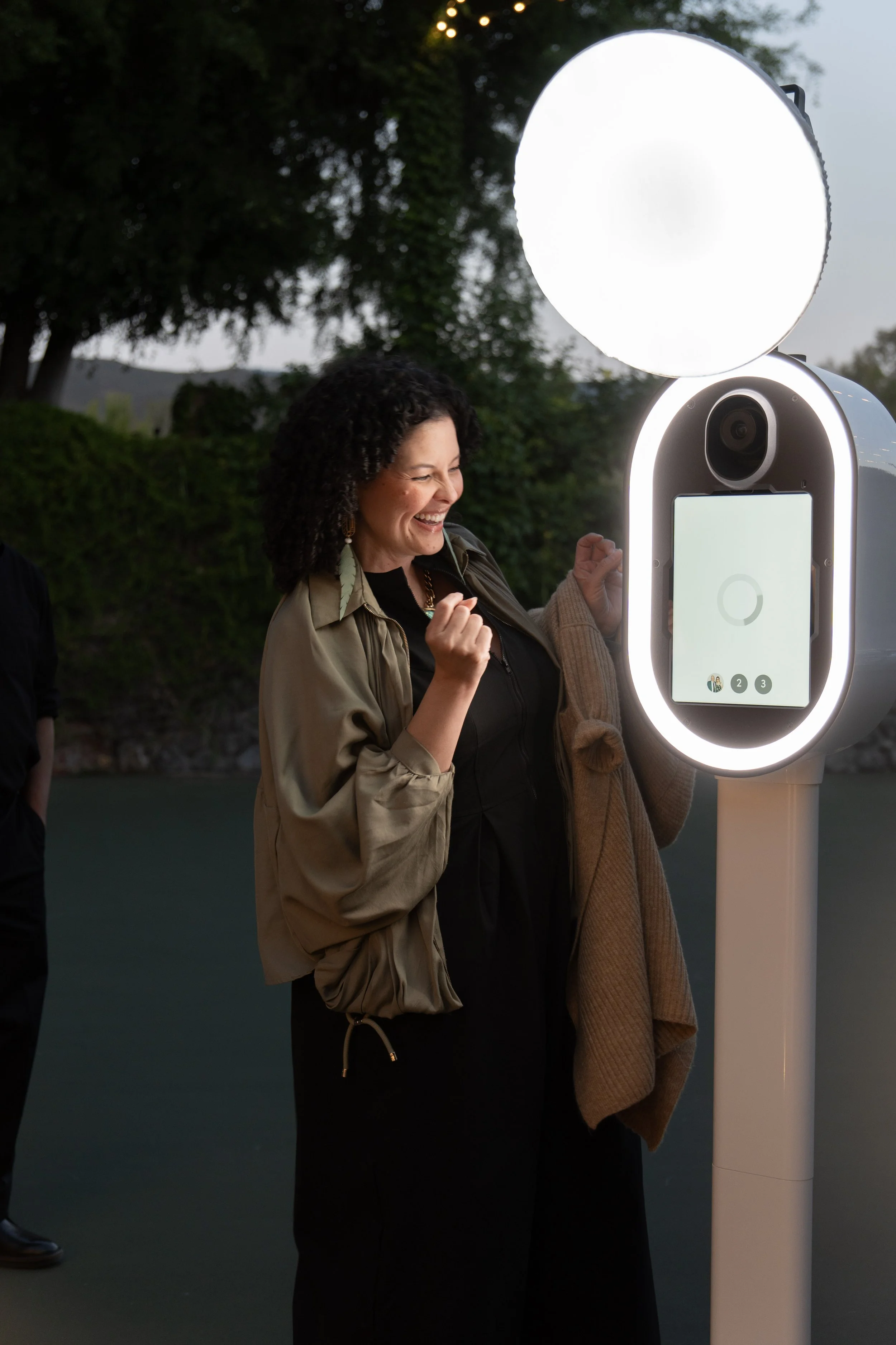 Florie M, Co-Founder and Smile Specialist at Luxelle, using the photo booth at a wedding