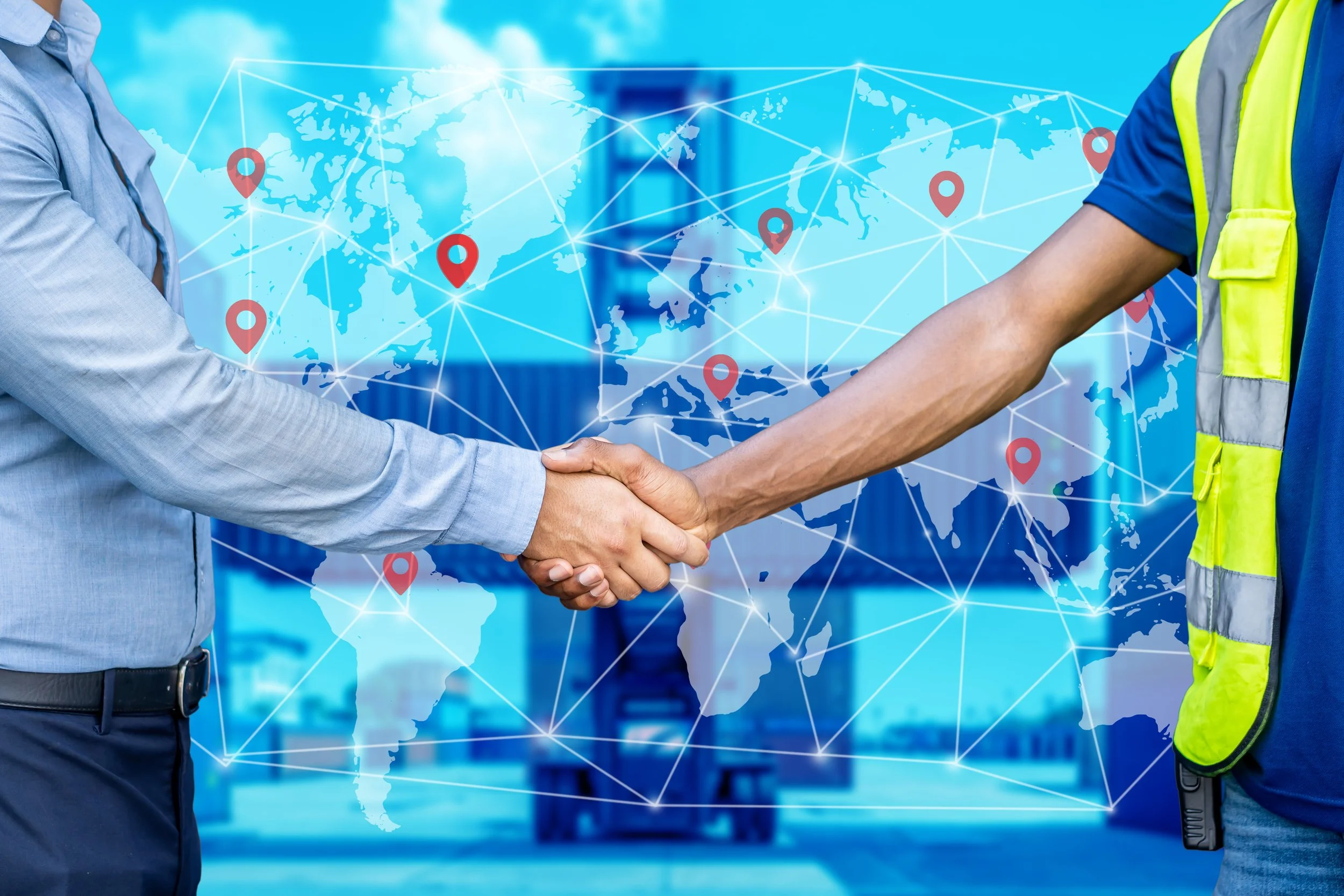 Two people shaking hands in front of a digital world map with location pins and connecting lines, symbolizing global collaboration or international business.