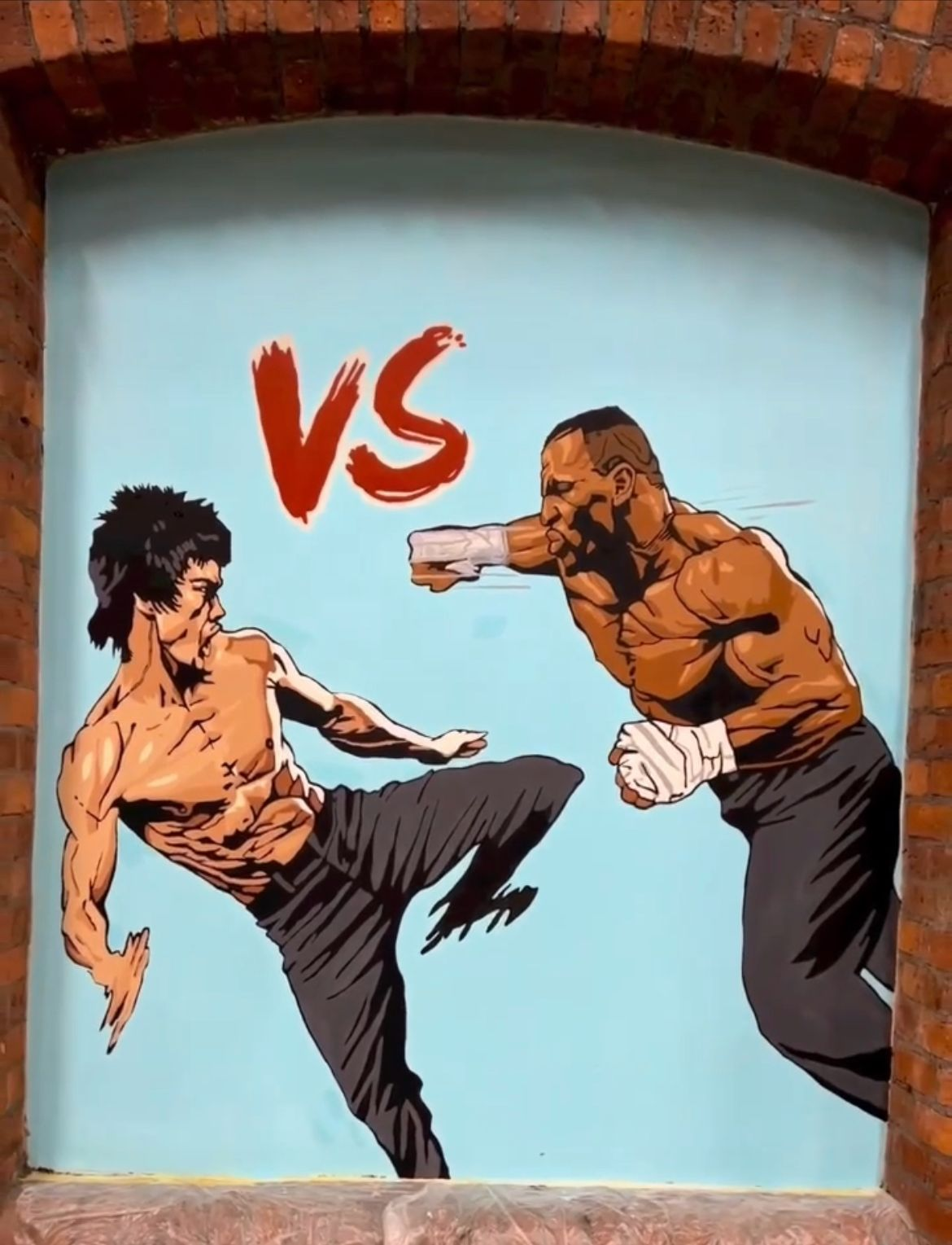 Graffiti art of a martial arts fight scene with a young man executing a high kick against a muscular man in a fighting stance, with 'VS' in red above them.