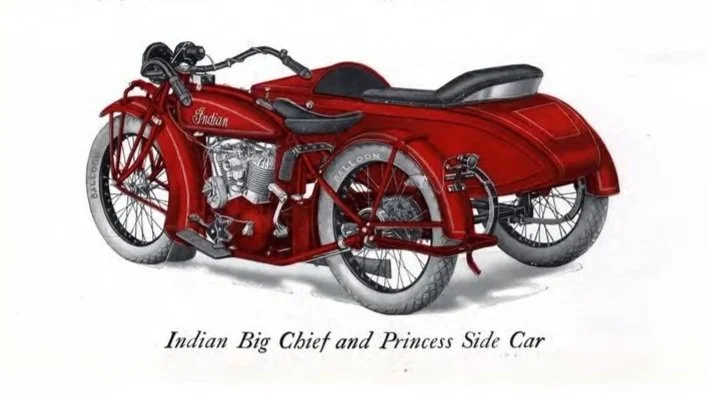 A red Indian Big Chief motorcycle with a matching sidecar labeled Princess, featuring vintage design and chrome detailing.