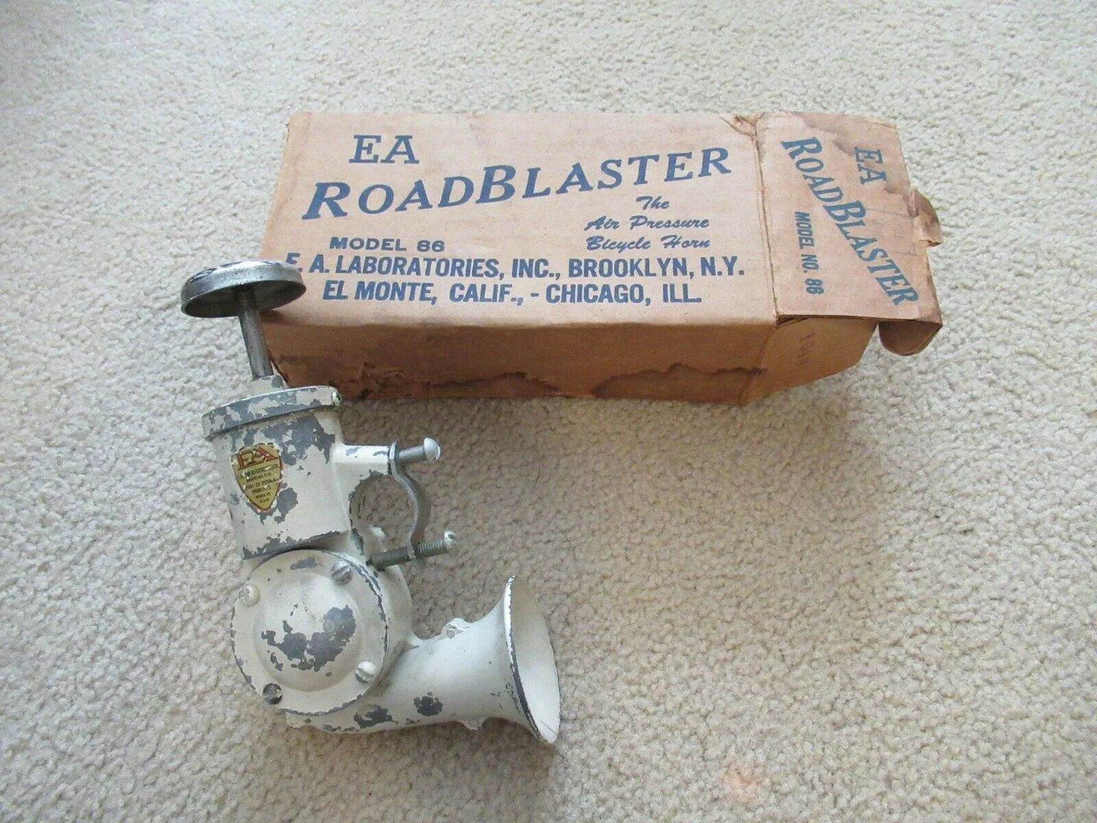 Vintage EA Road Blaster air pump with its original box on beige carpet.