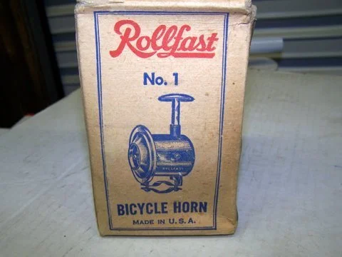 Vintage Rollfast bicycle horn in its original packaging, labeled as No. 1, made in the U.S.A.