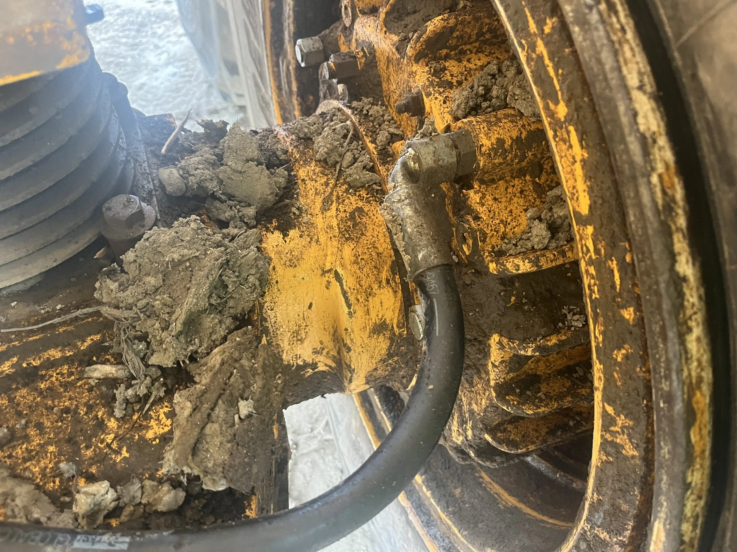 hydraulic brake line on a Volvo articulating dump truck. Brake line is bent causing loss of brake power on this hub.