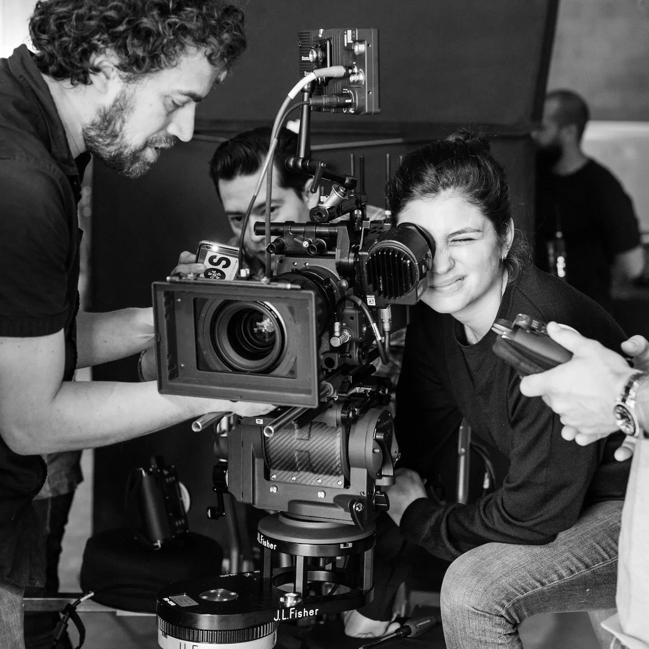 People working with a professional film camera on a film set.