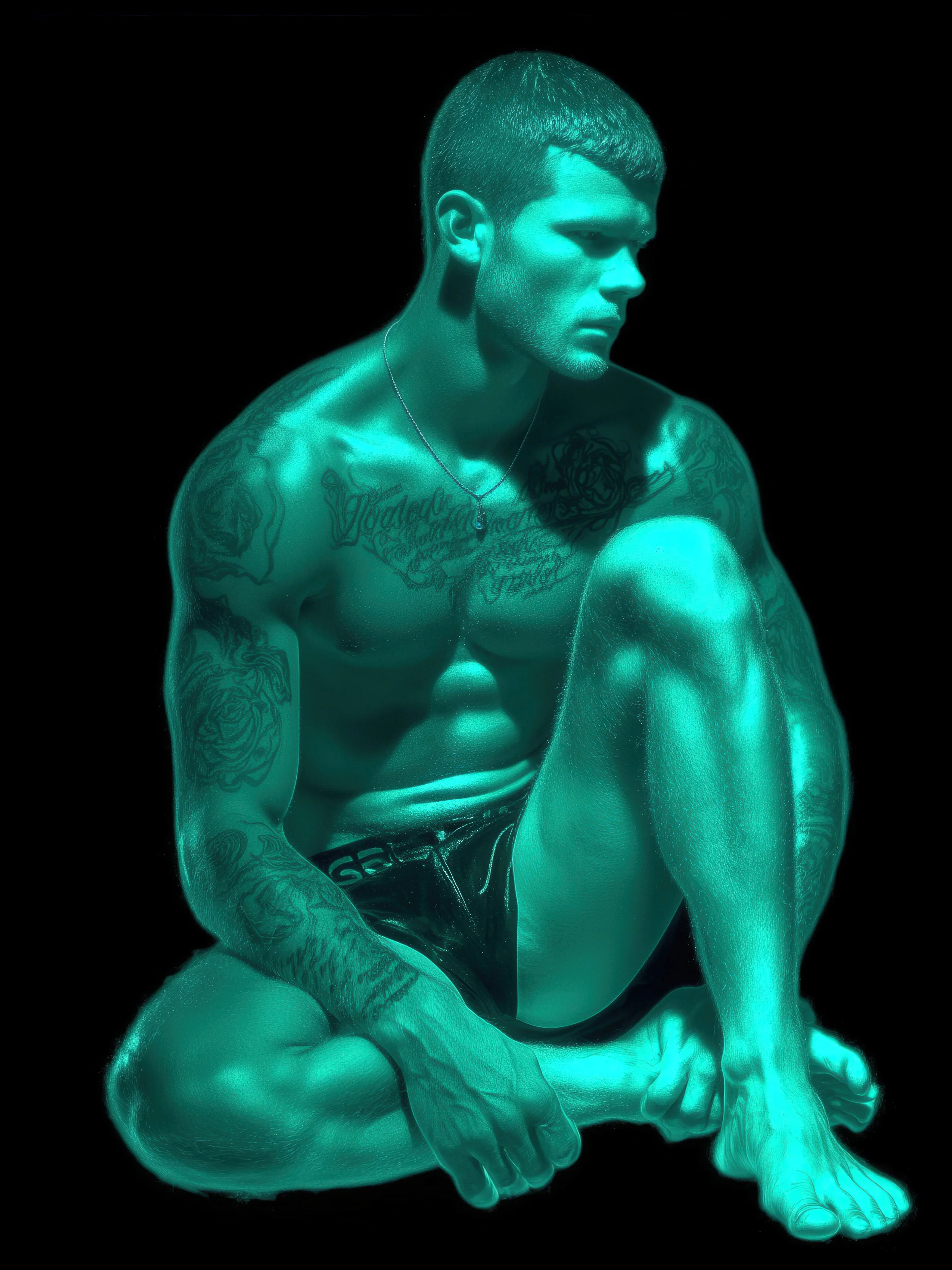 Dirt & Divine male art of a handsome, athletic, rugged man with tattoos on a black background. Jade colours