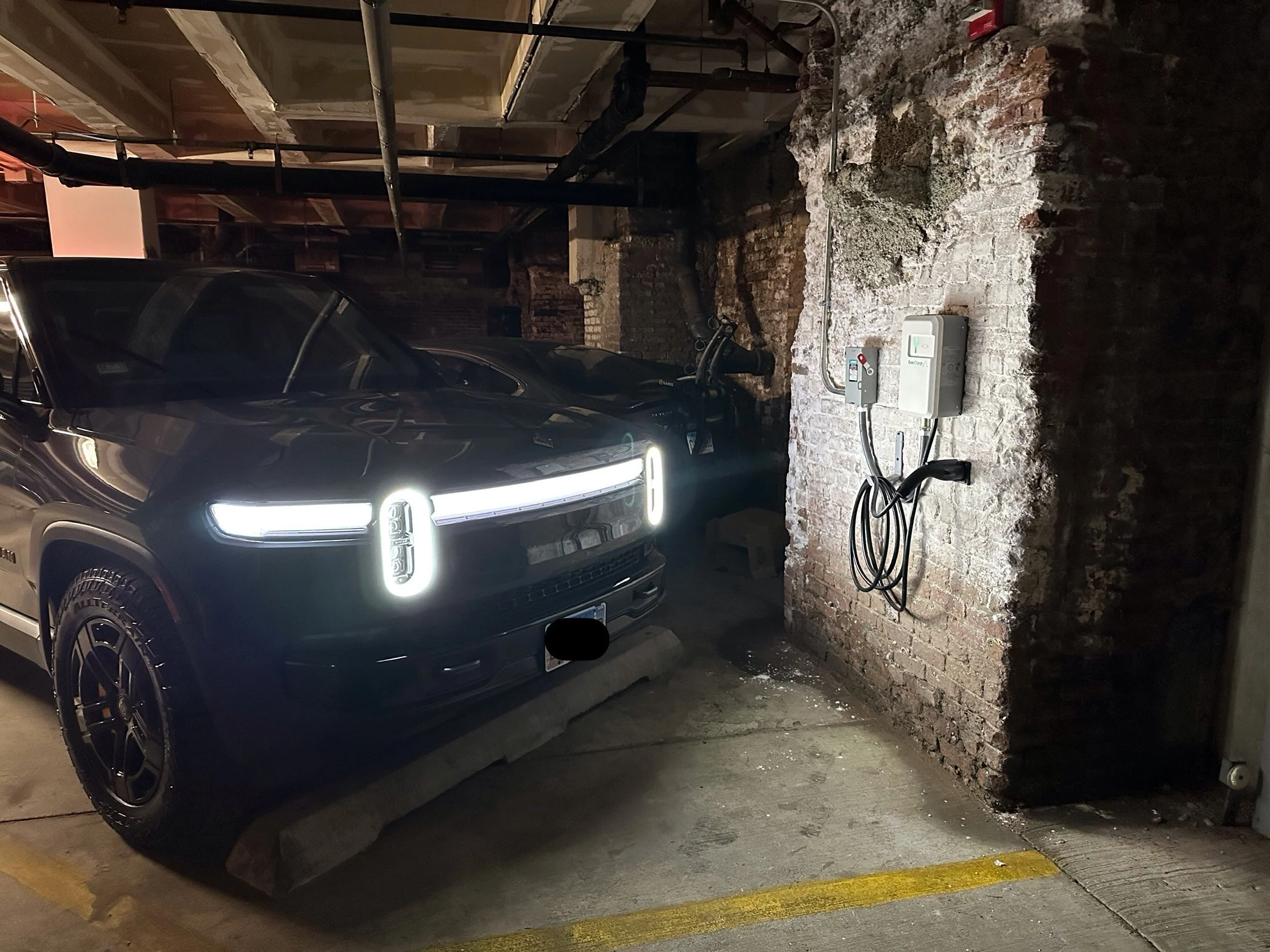 Installed EverCharge EV02 Level 2 charger connected to shared make-ready infrastructure in Chicago condominium parking garage