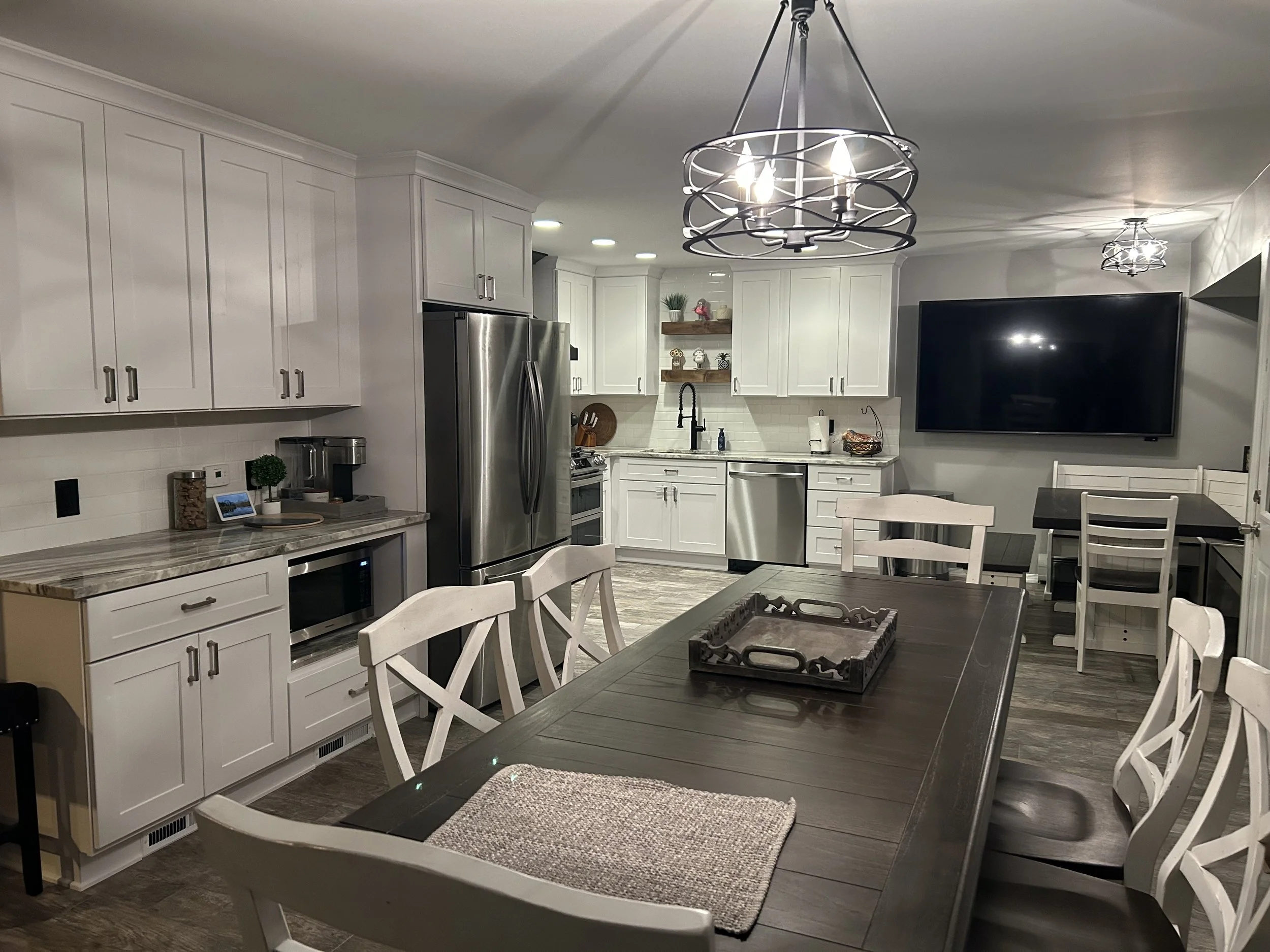 Modern kitchen with white cabinets and stainless steel appliances create that stunning transformation.