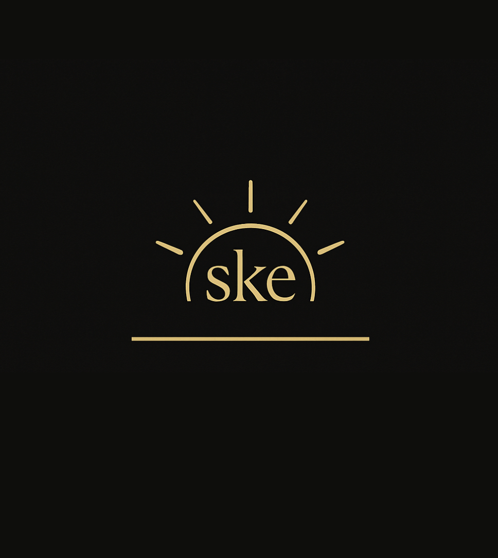 Gold logo with the word 'ske' inside a partial circle resembling a rising sun, with lines radiating outward, on a black background.