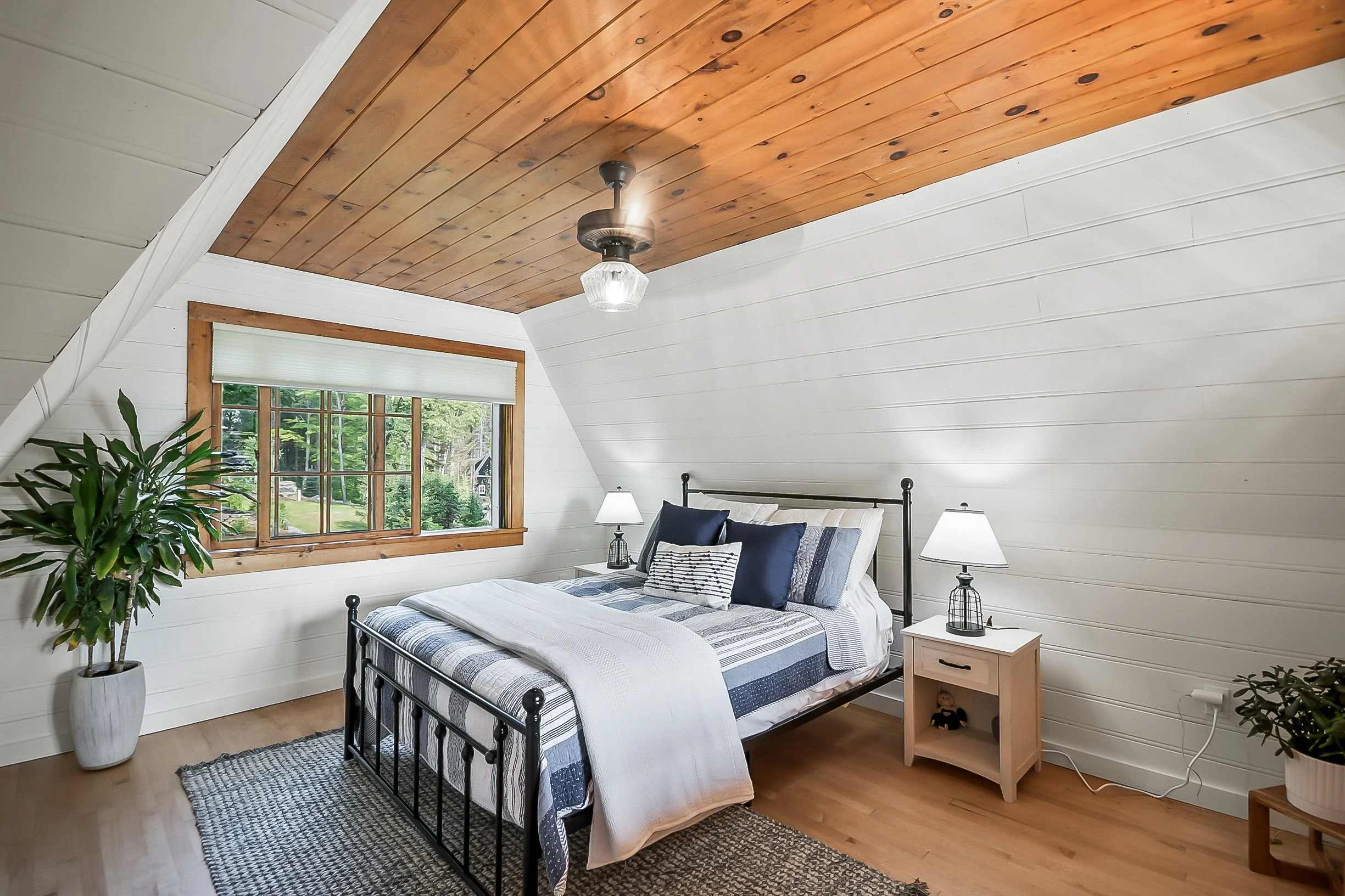 The Blue Room: Queen bed with shared bath on the second floor in the main cottage, with forest views and a glimpse of the lake.