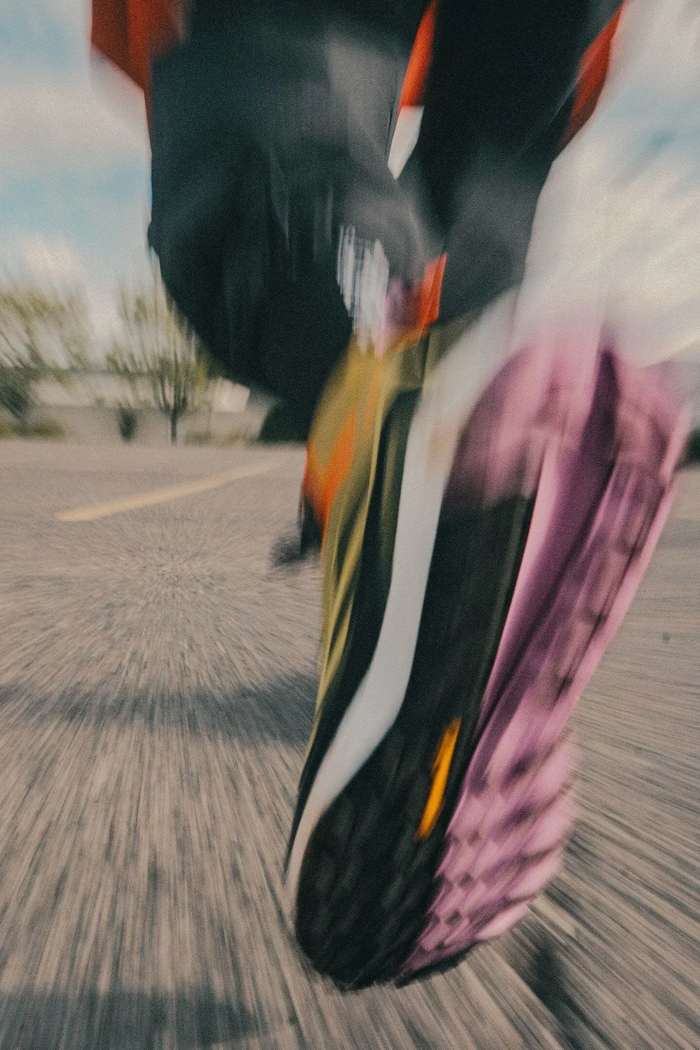 Close-up of a motorcycle tire in motion on a paved road.