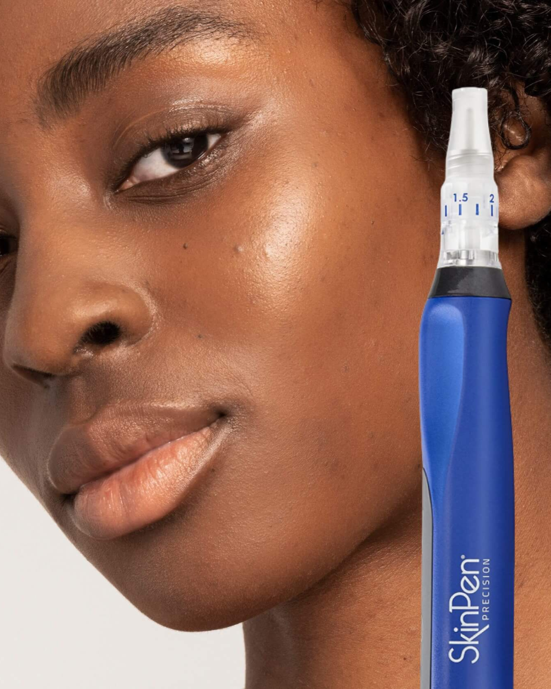 a model with smooth skin with a skinpen microneedling device in front