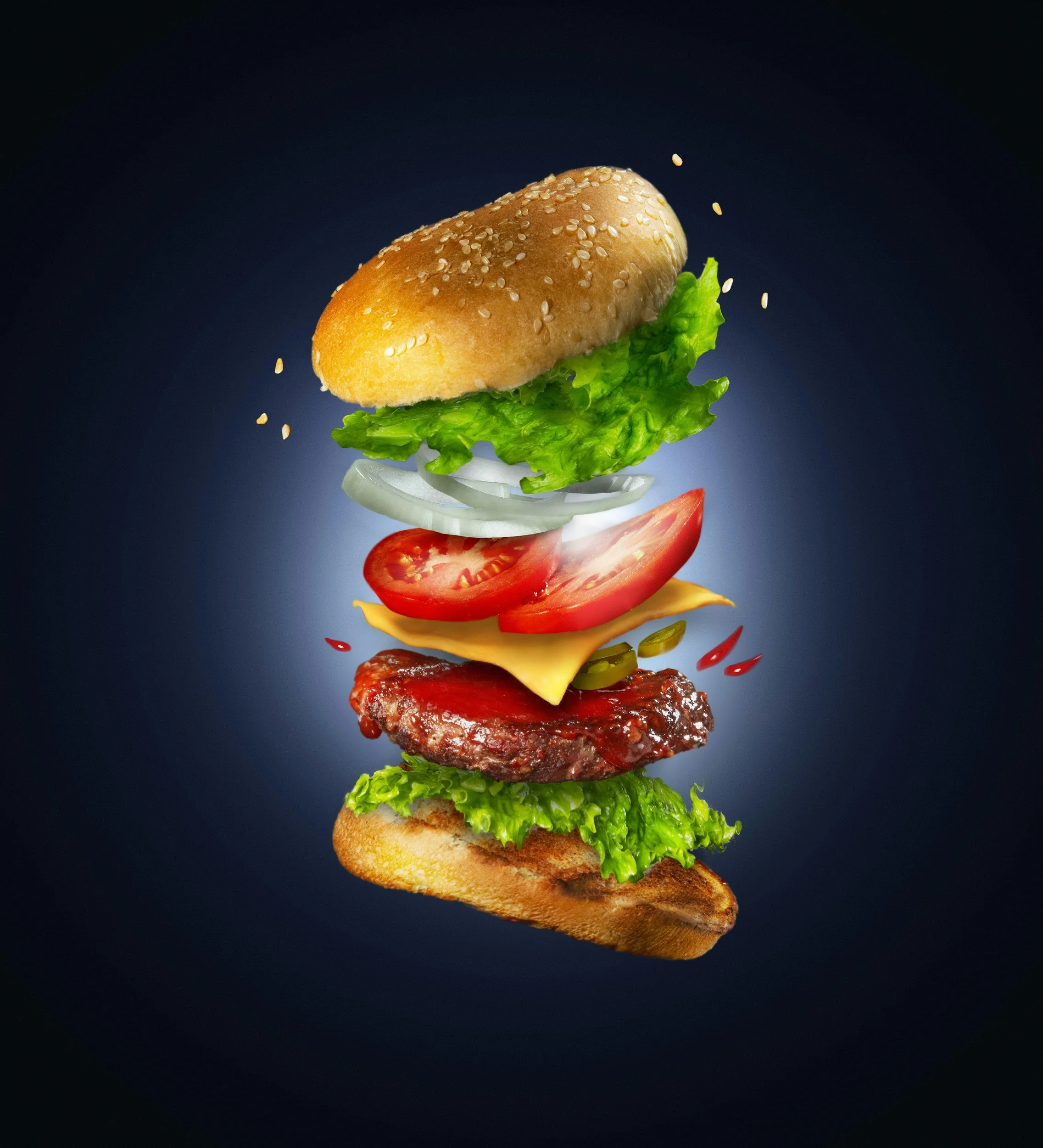Floating burger with bun, lettuce, onion, tomato, cheese, beef patty, pickles, and bottom bun on a dark background.