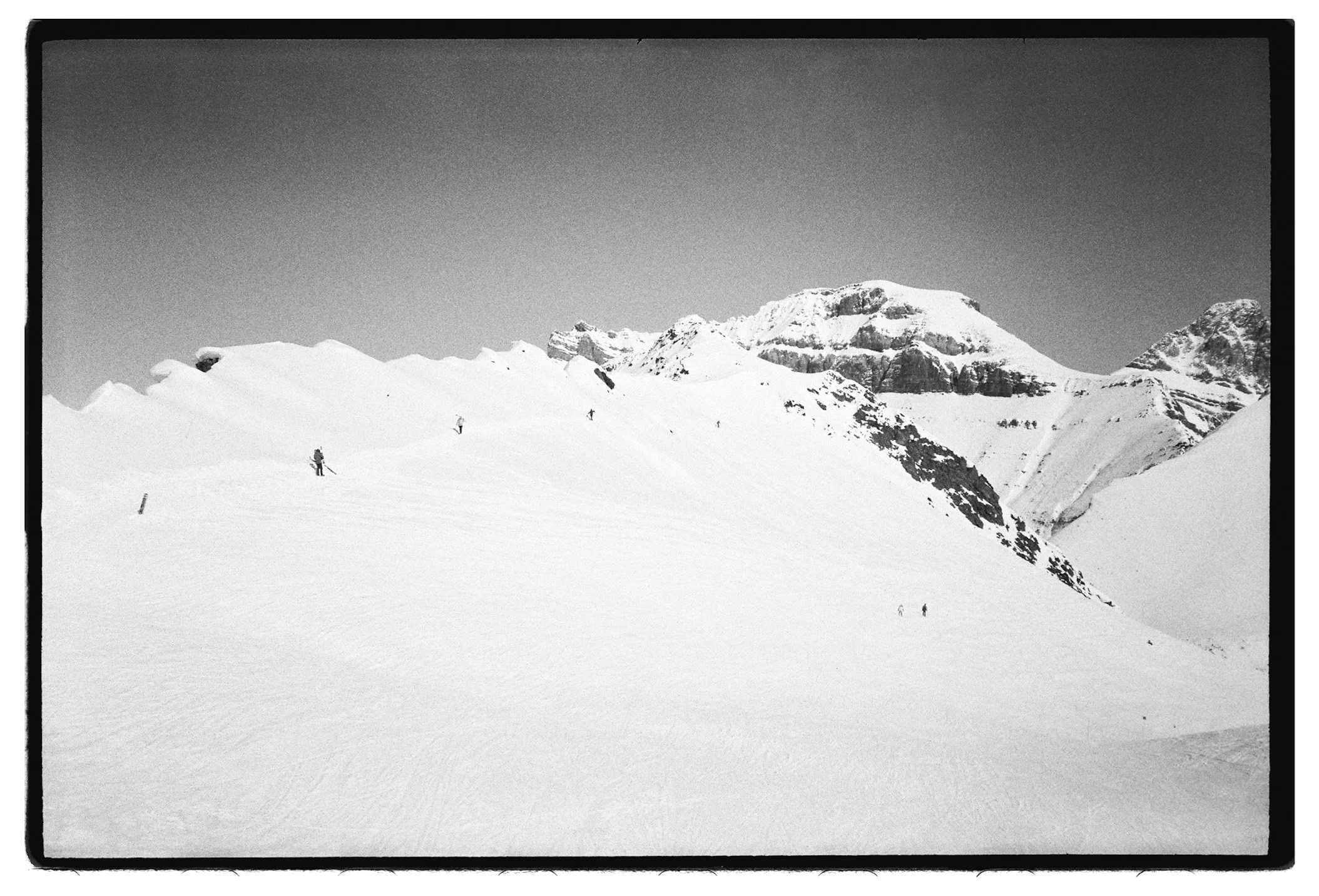 black white 35mm film ski mountaineering, ski traverse mountain, black and white mountain film