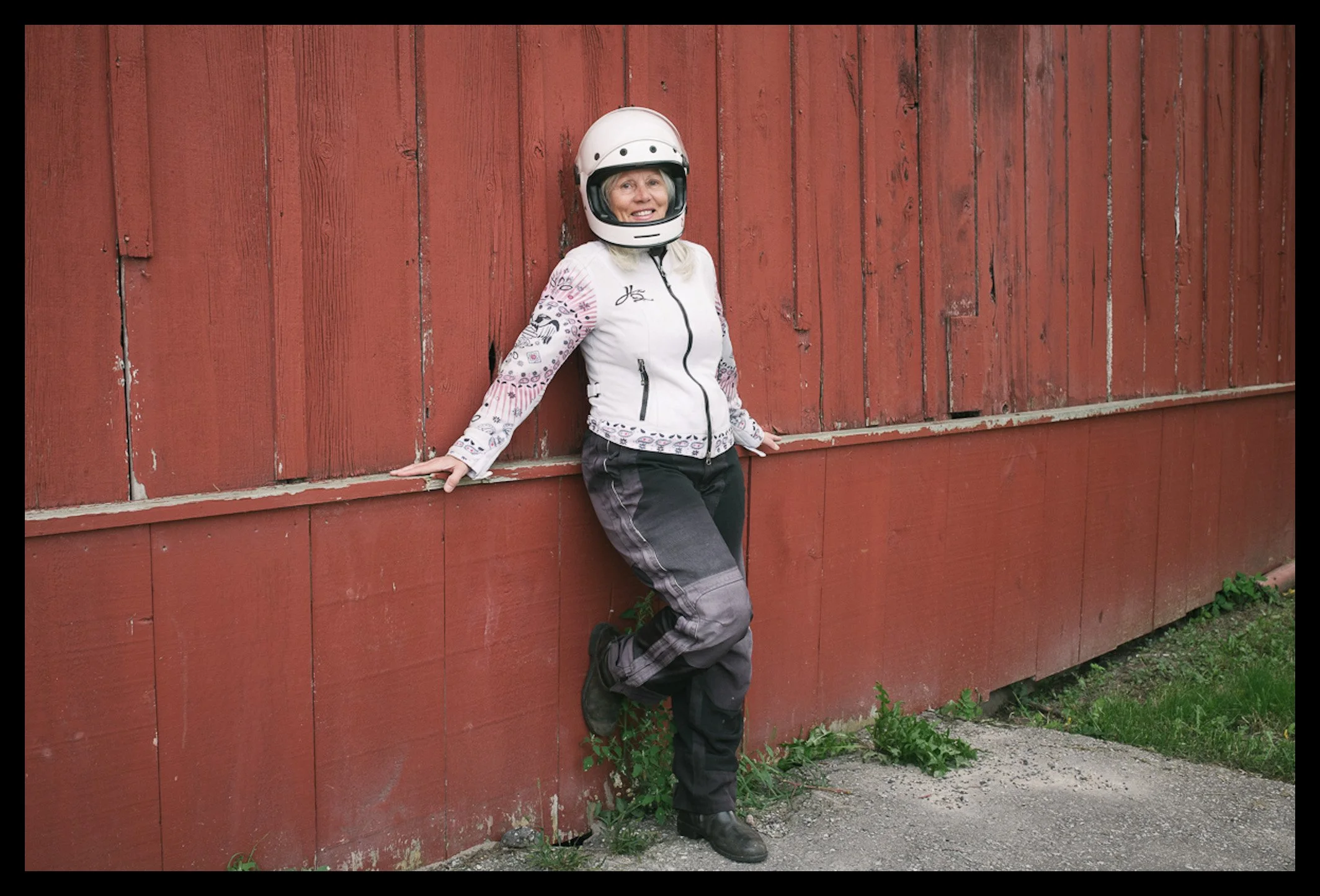 Female motorcycle rider portrait natural light colour in motorcycle gear 