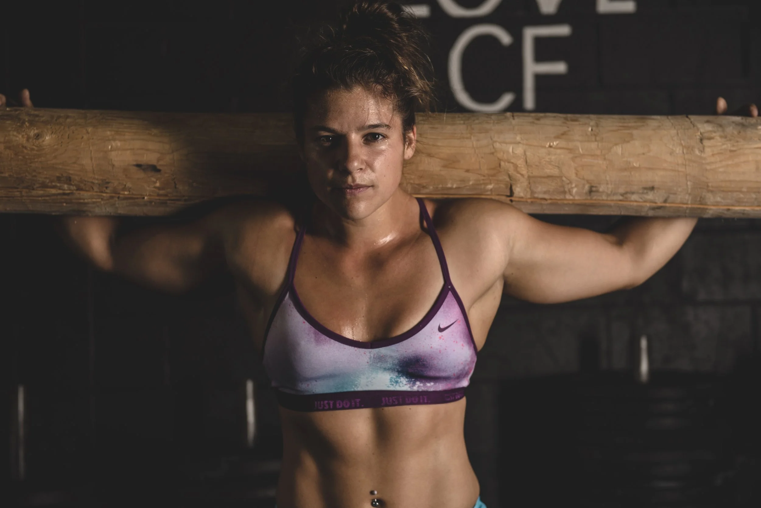strong fit woman environmental portrait crossfit gym. sports bra athletic woman shot for editorial magazine health and fitness 