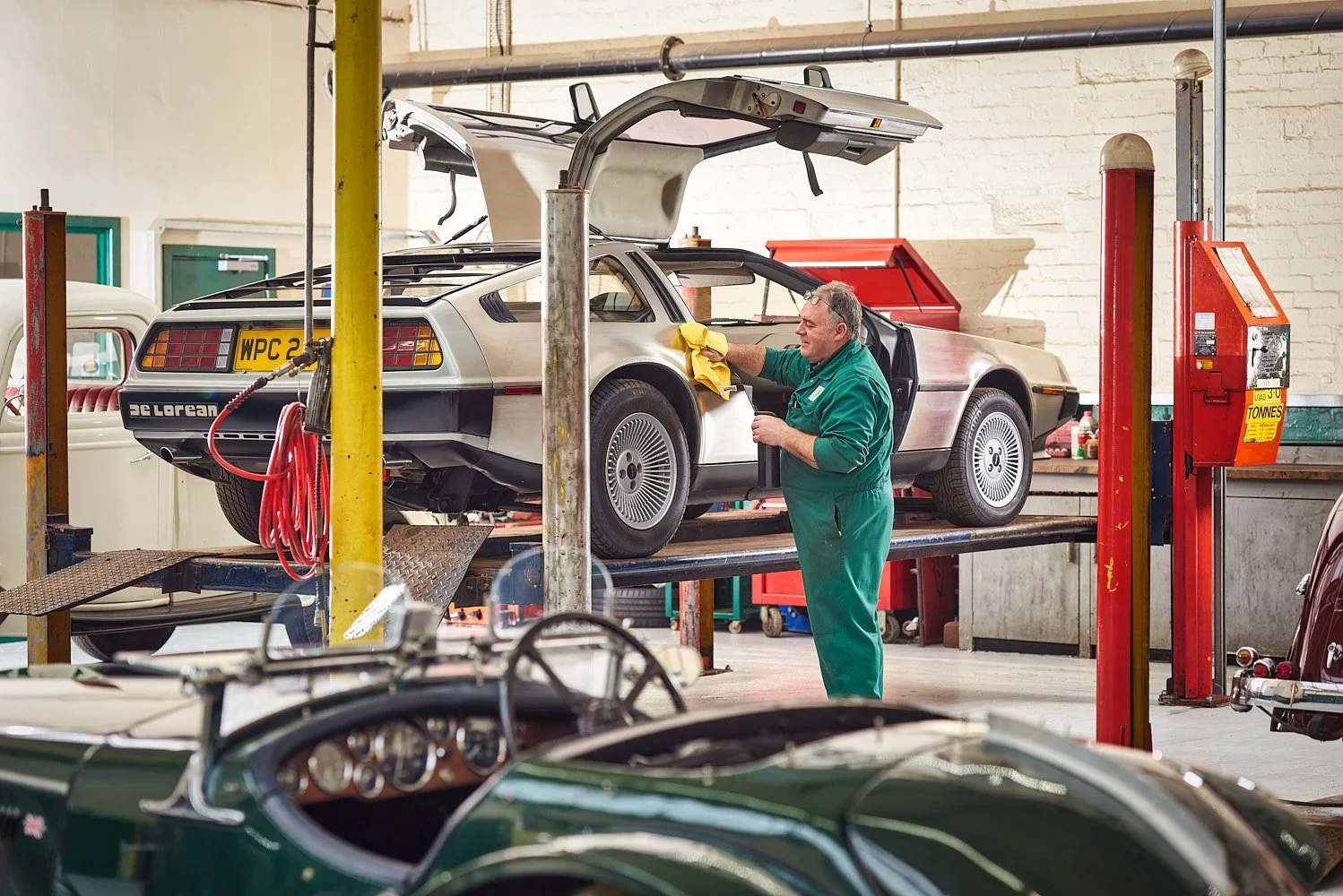 Classic sports car full profile shot for marketing or collector purposes DMC Delorean DCM-12 in repair garage Holmfirth
