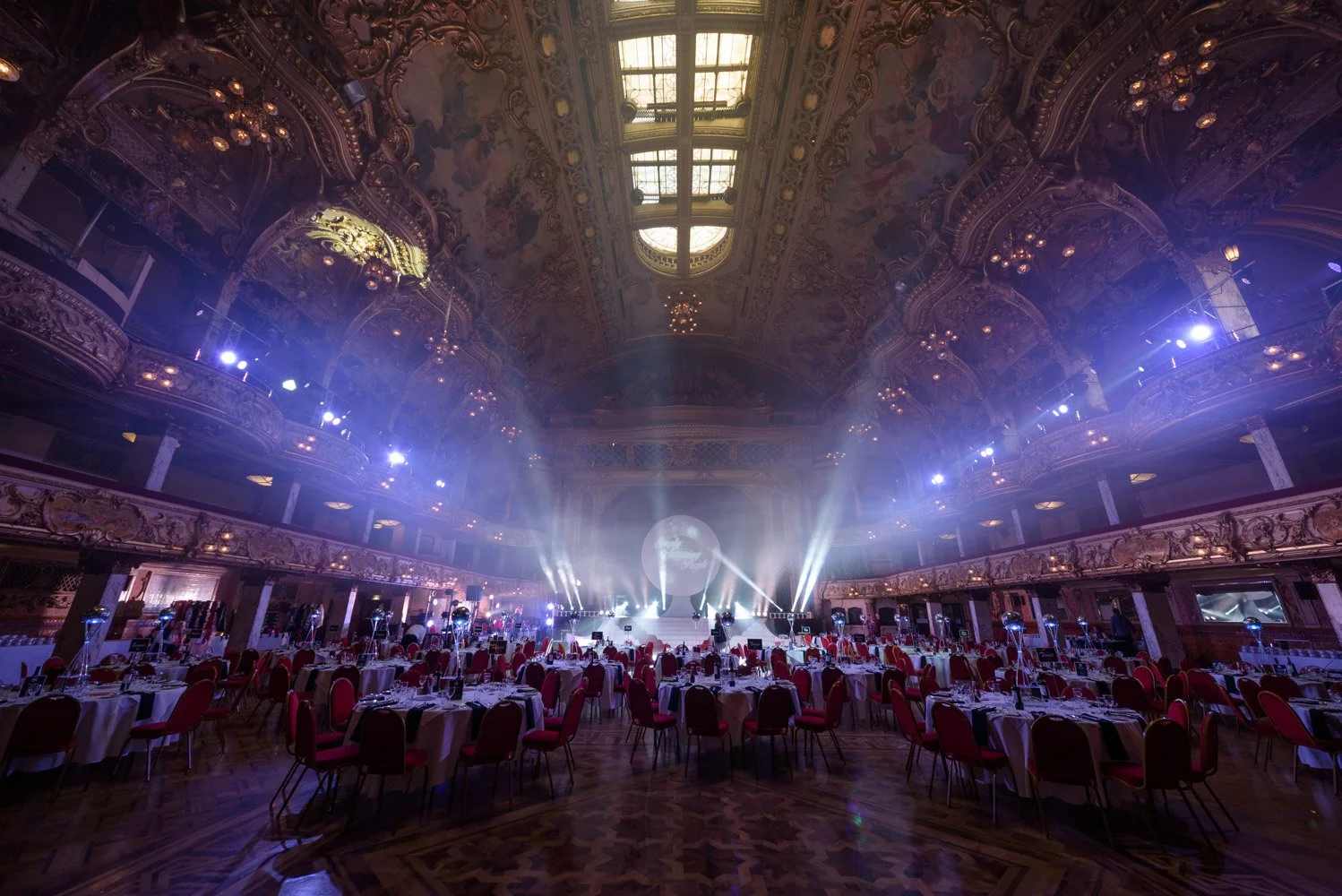 Wide venue shot of large-scale corporate event with full production