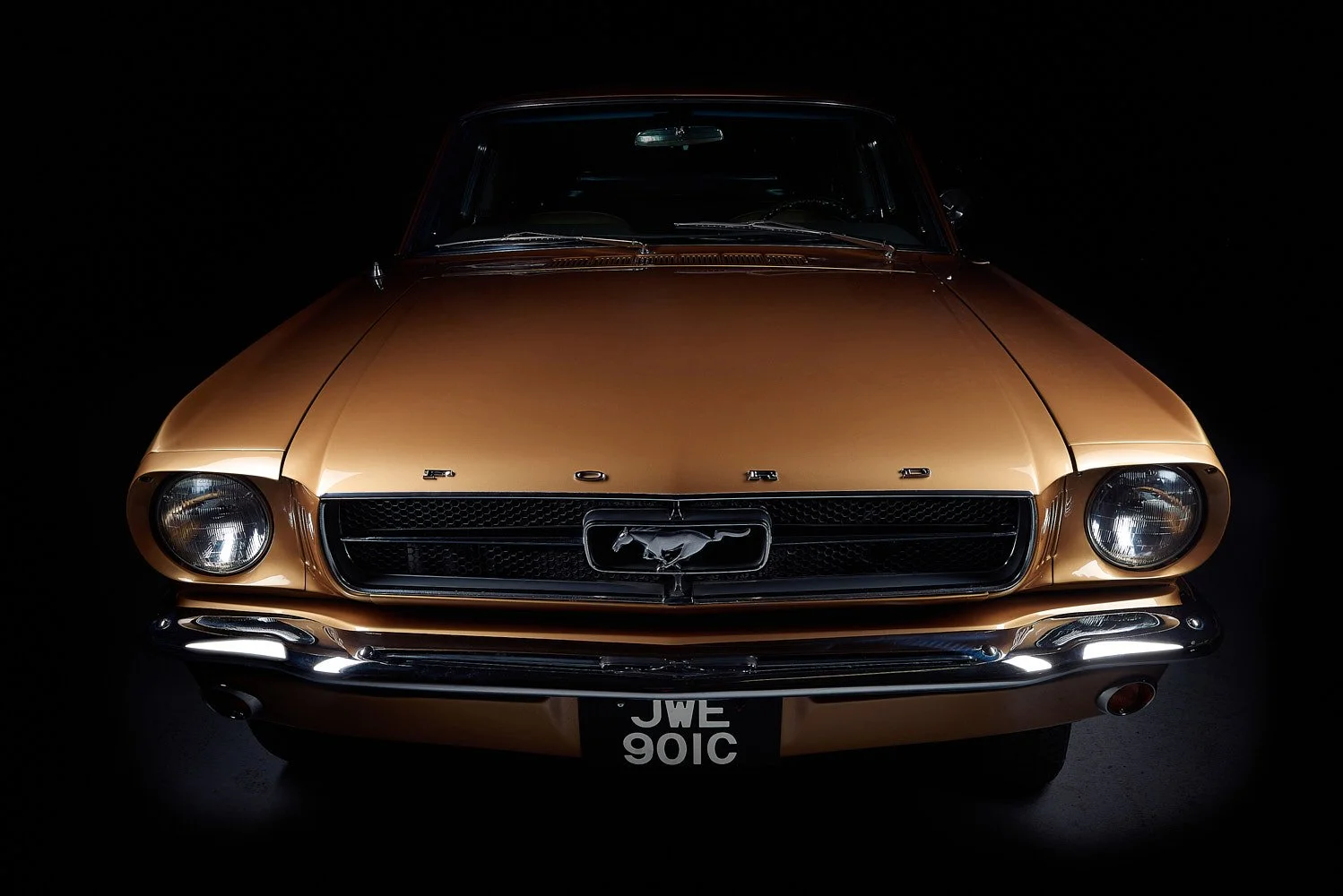 Front view of vintage Ford Mustang car on a dark background