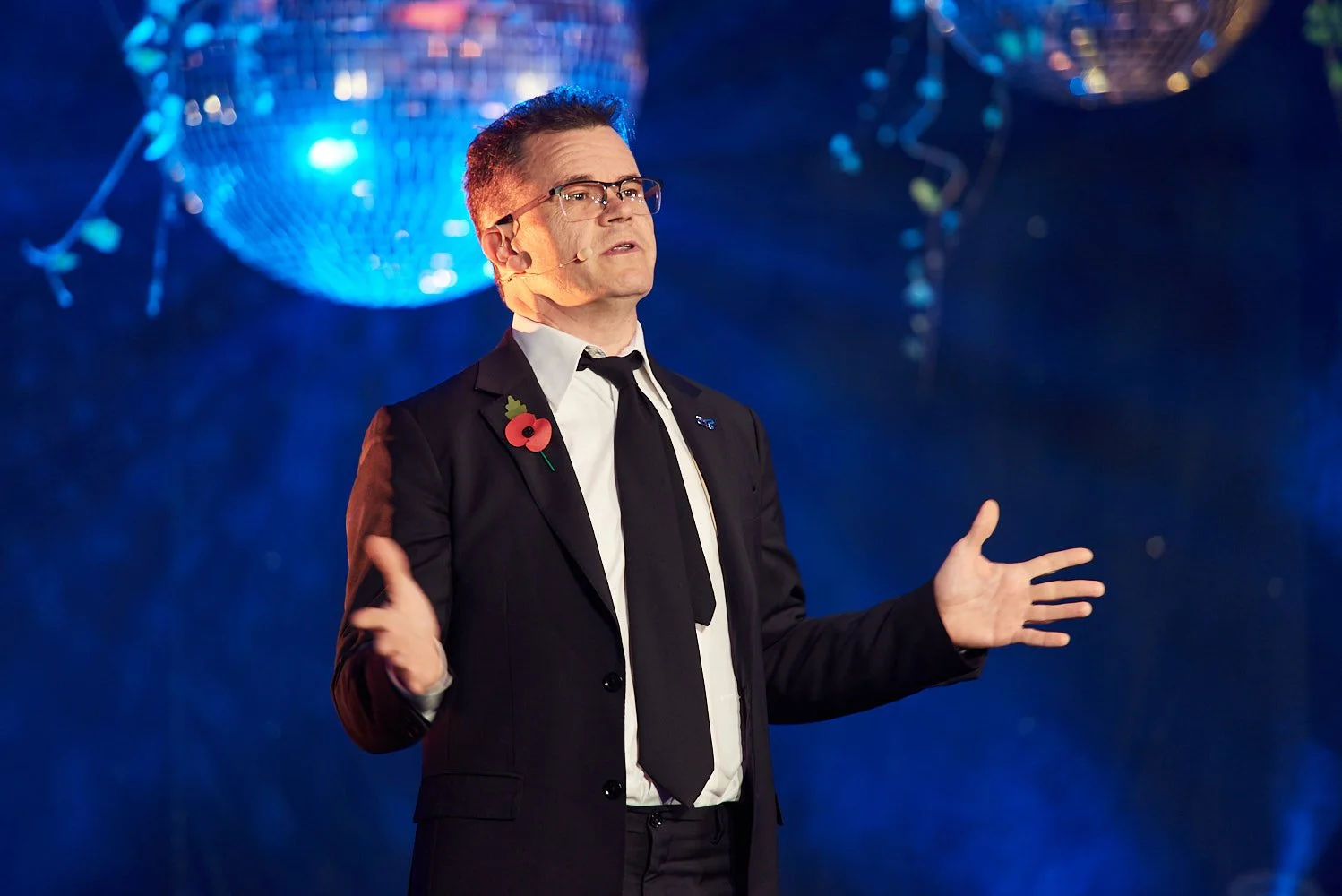 Dominic Holland delivering comedy speech at corporate event
