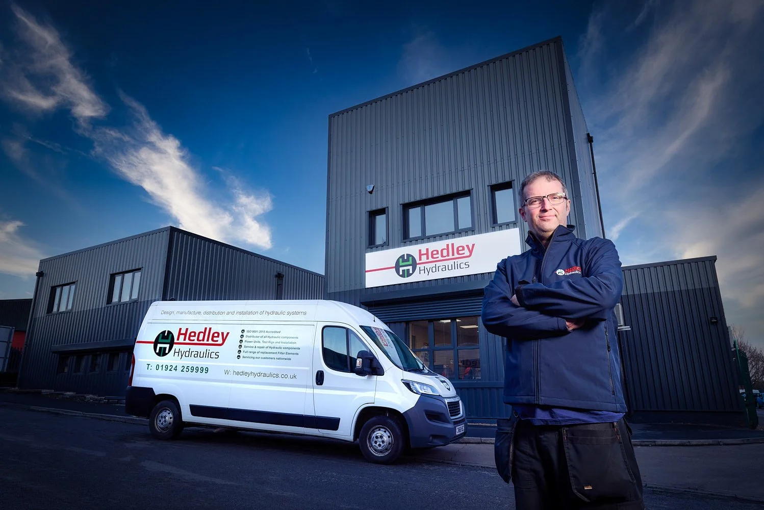 Corporate headshot with branded background for Hedley Hydraulics