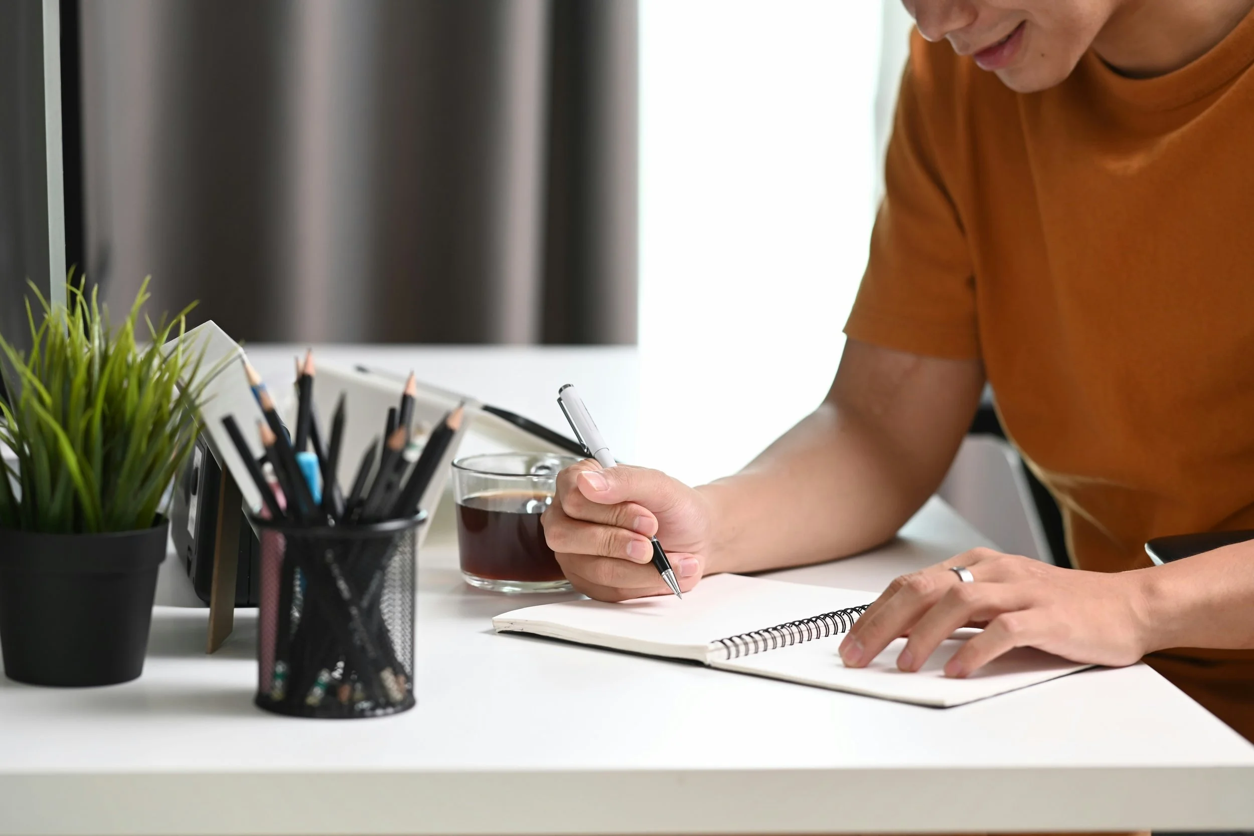 person writing in a notebook