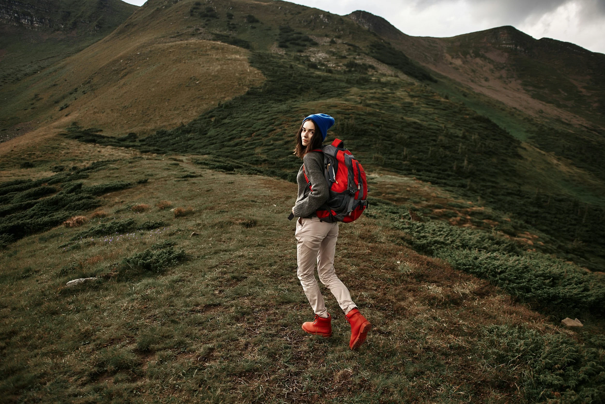 woman hiking on a hilltop