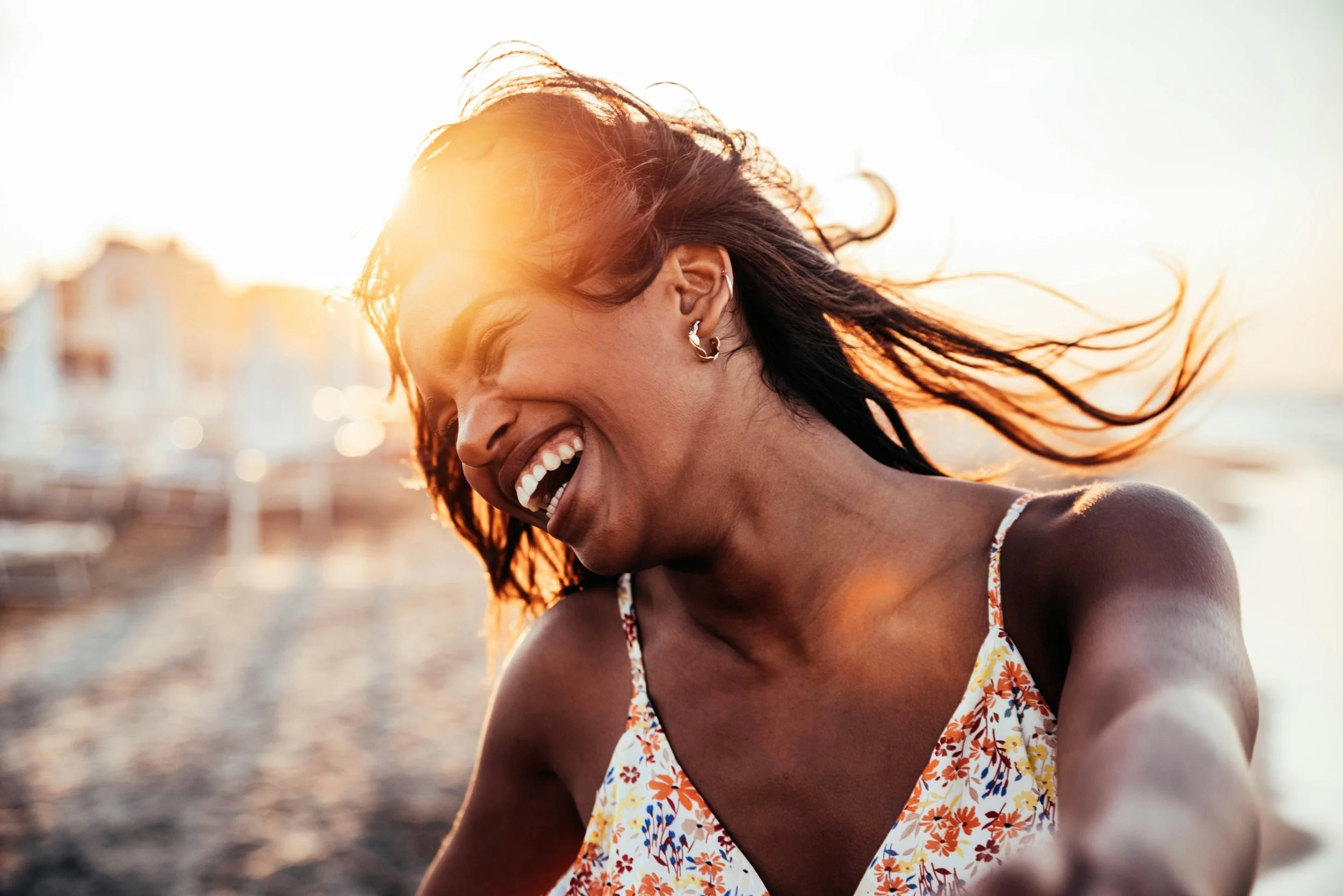Woman smiling and laughing outdoors after treatment for OCD in Ogden Utah