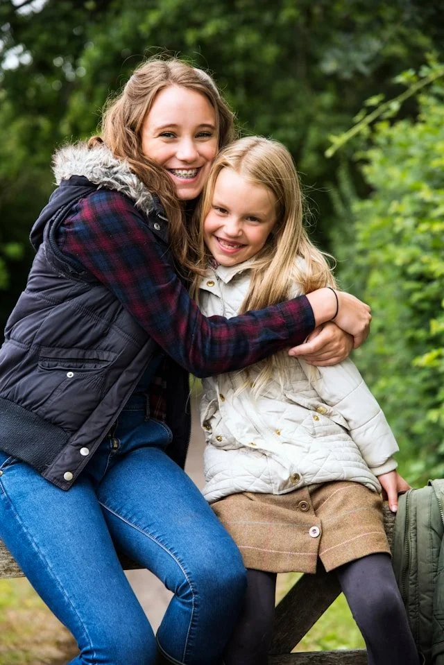 Older and younger sisters hugging outdoors representing connection and healing after depression treatment in Ogden Utah