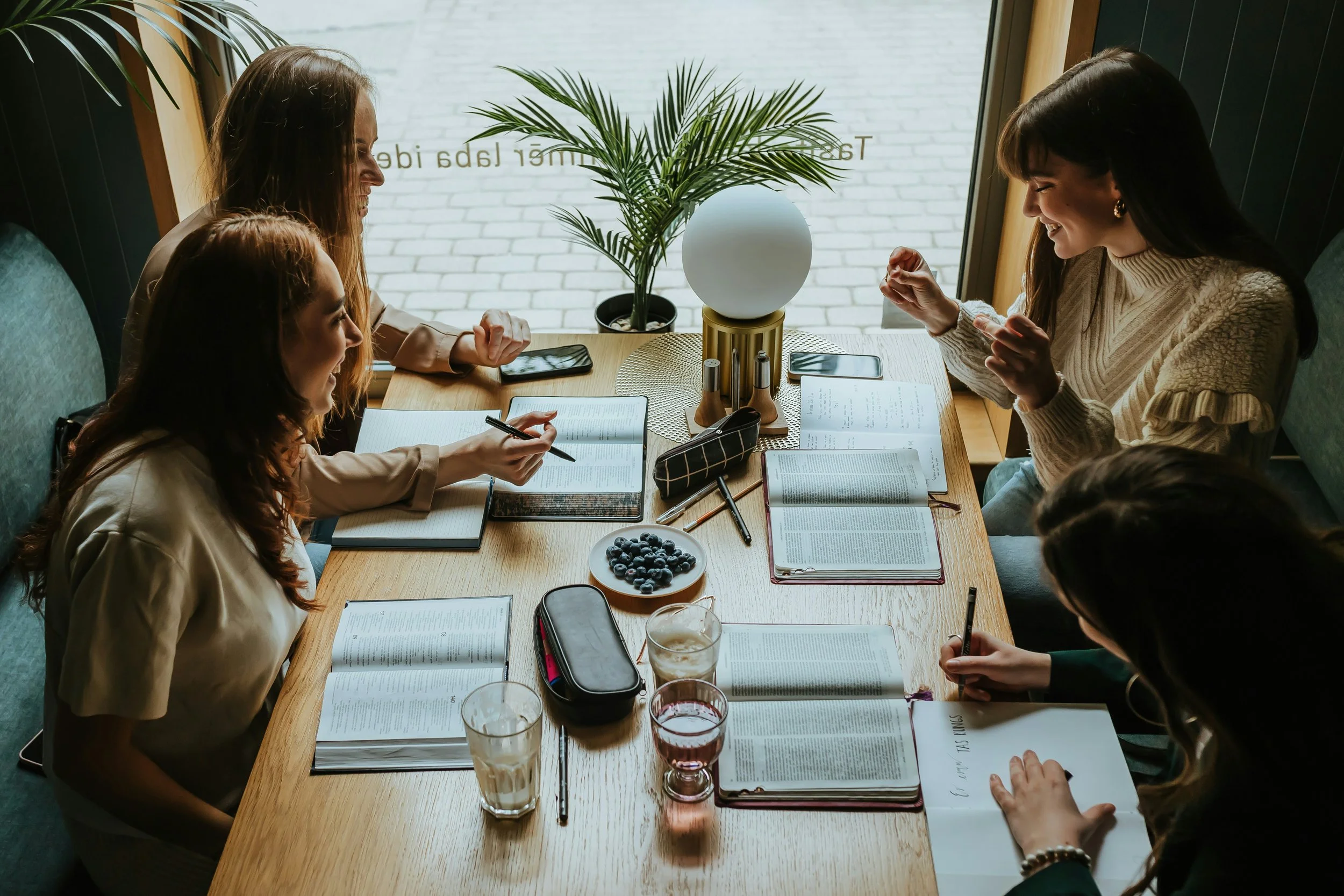 group of women sitting around a table