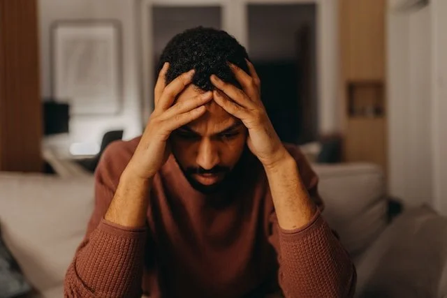 Man with head in hands experiencing depression and seeking treatment in Ogden Utah