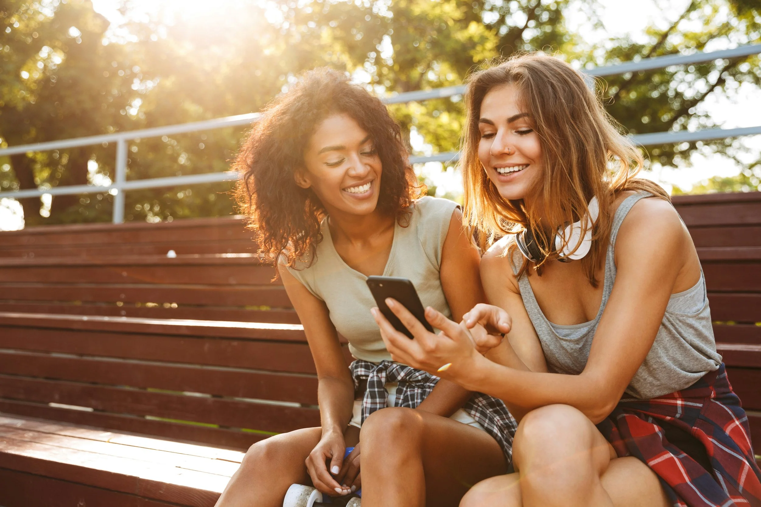 two women smiling looking at a phone
