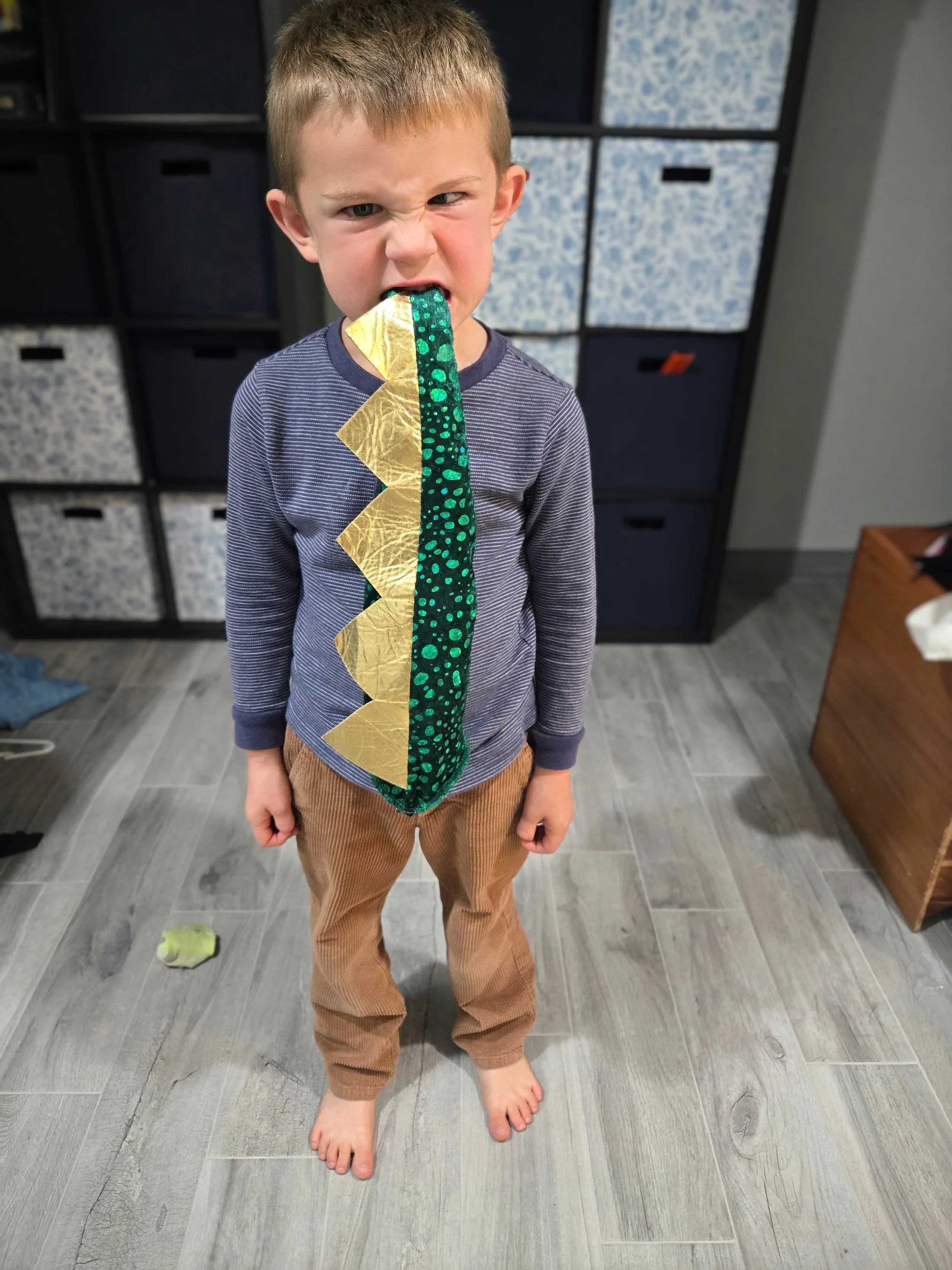 child with a pretend dinosaur tail