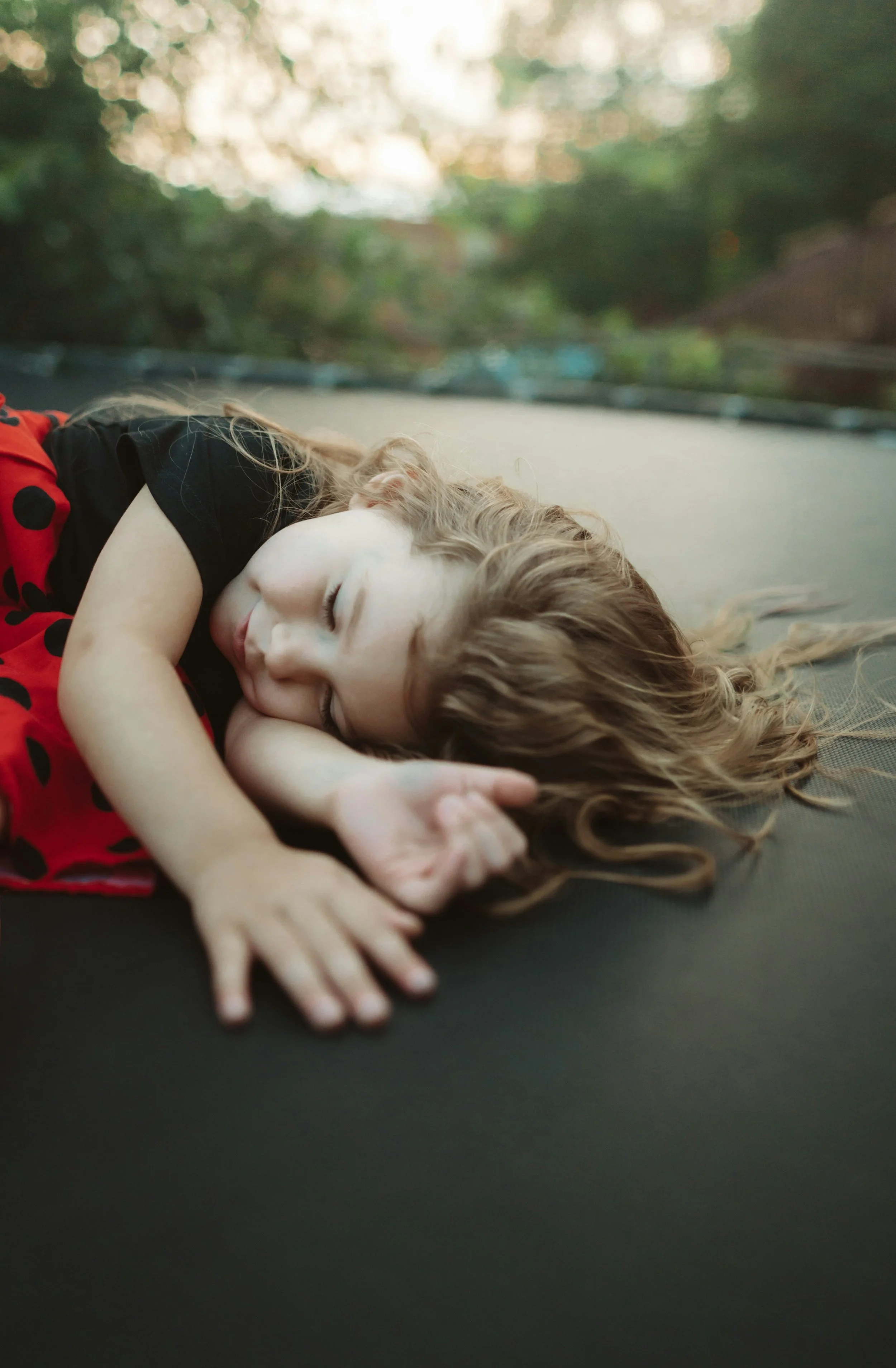 child sleeping on a trampoline