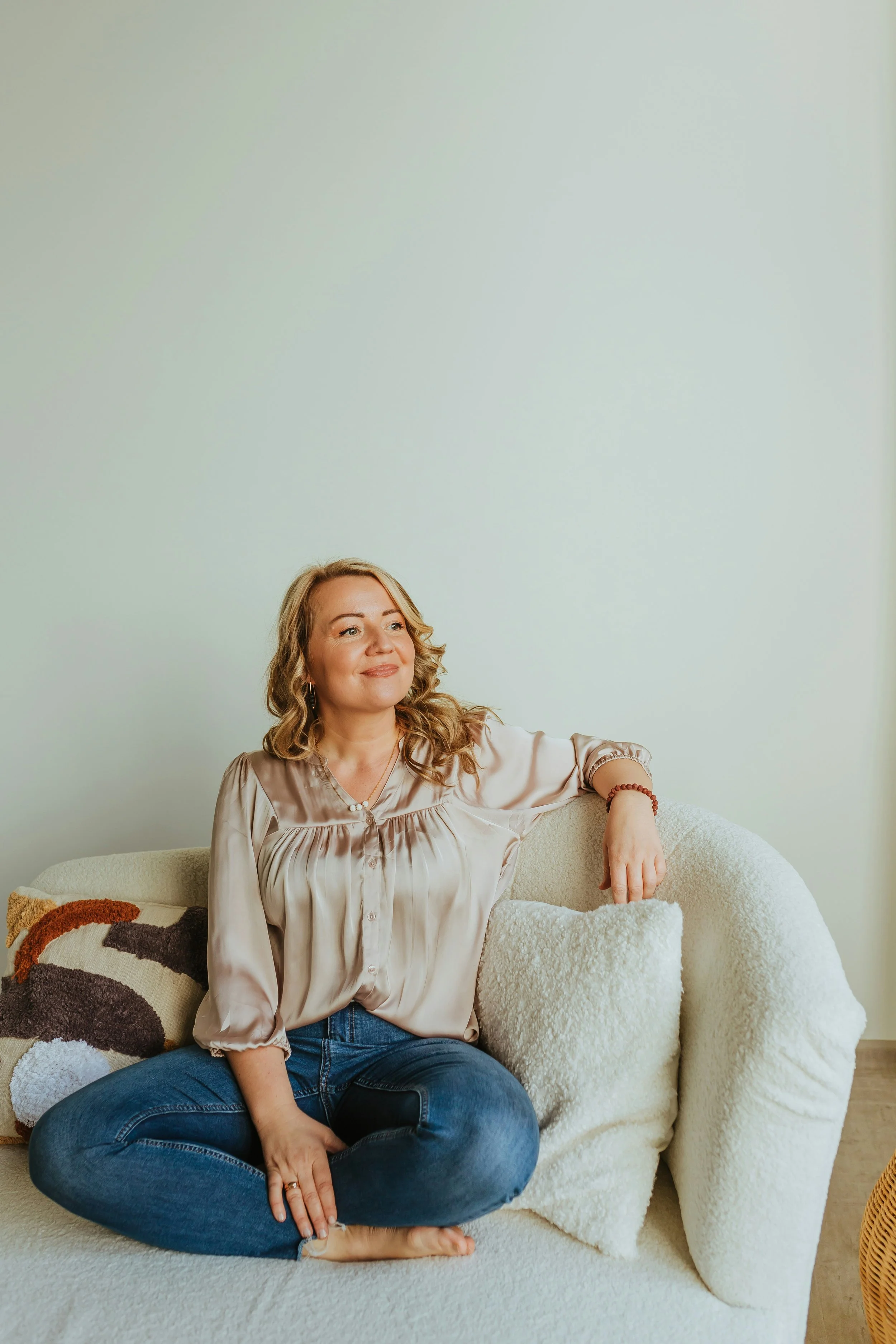 woman sitting on a couch smiling