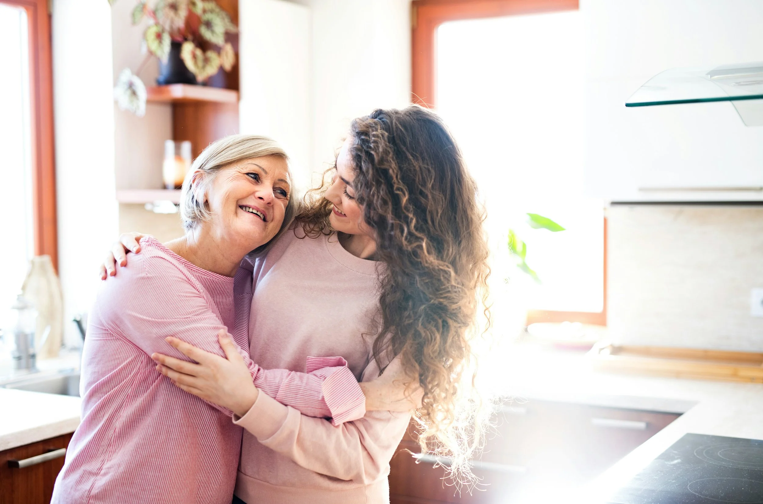 two women hugging and smiling