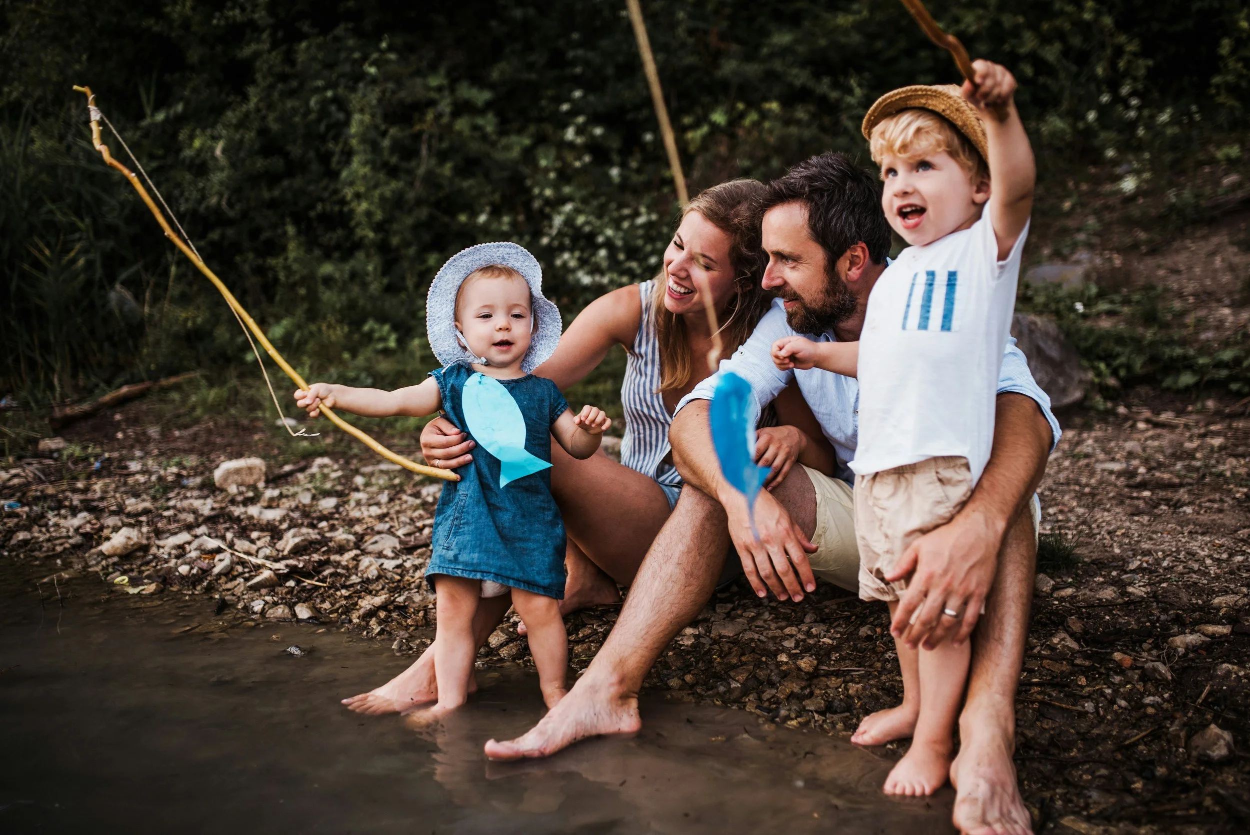 family pretend fishing in a river