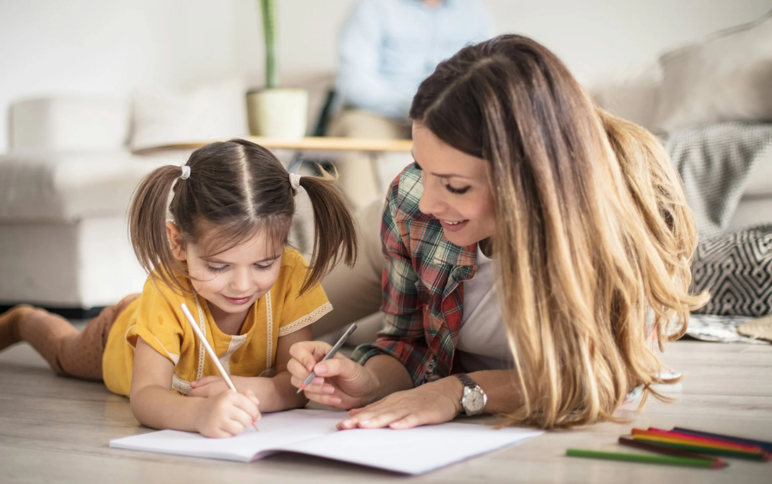 mother and daughter coloring together