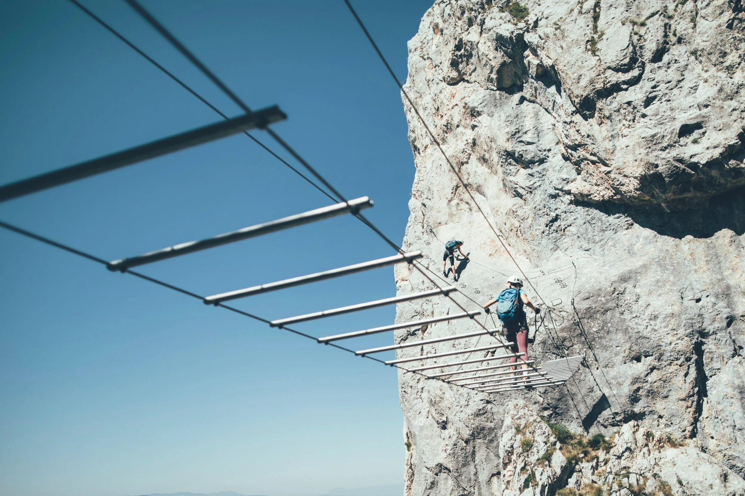 Couple walking across a suspension bridge representing exposure therapy for phobias and anxiety in Ogden Utah and the Wasatch Front