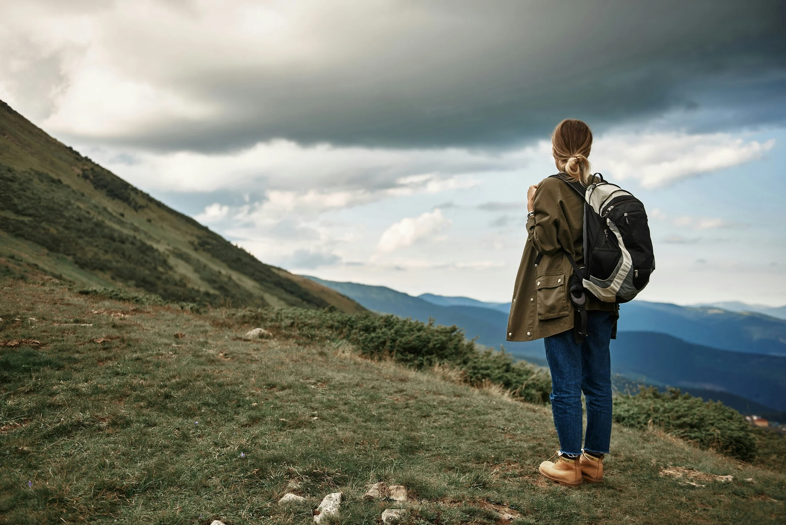 woman standing on top of a hill