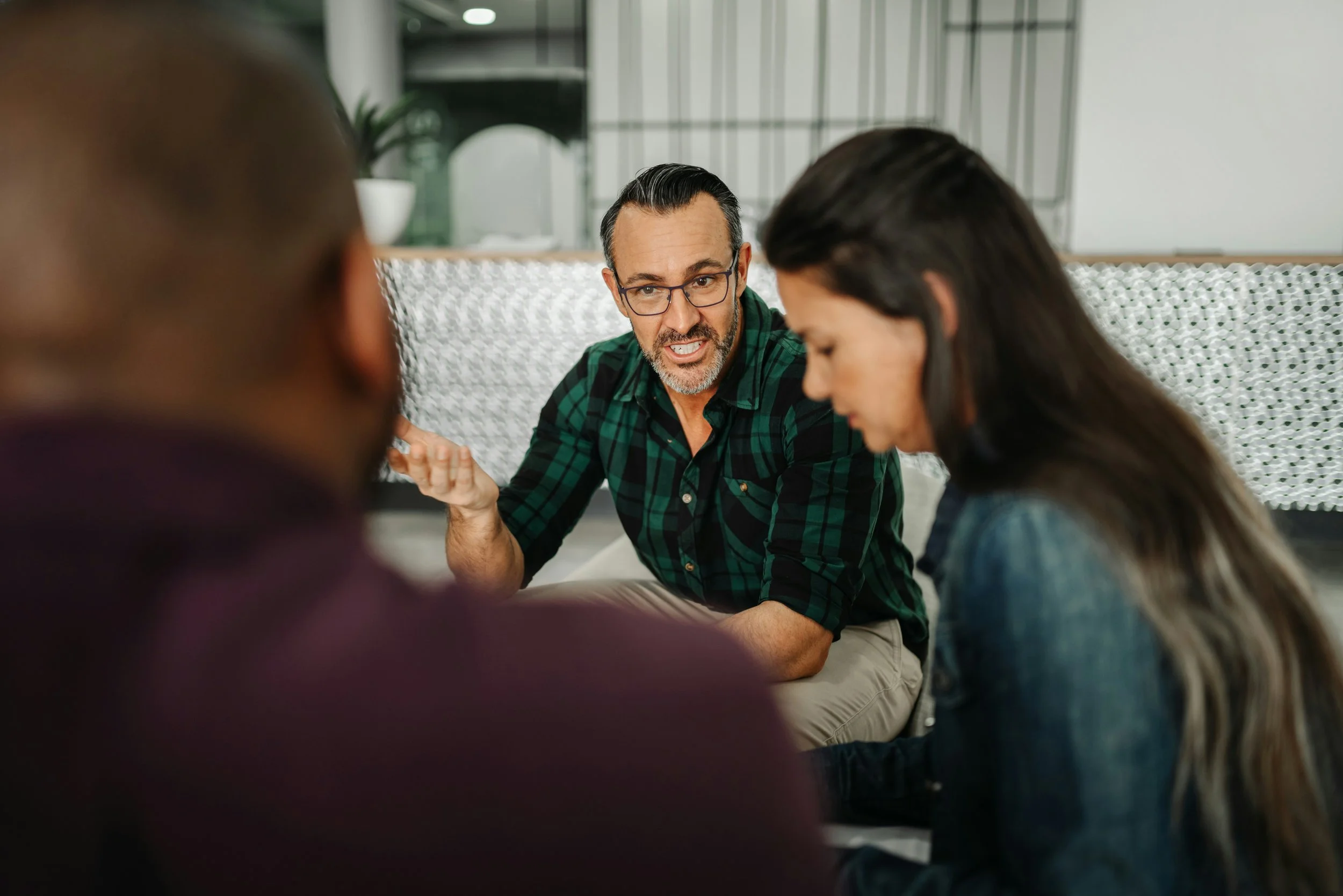 Couple discussing relationship concerns with therapist during couples counseling session in Ogden Utah