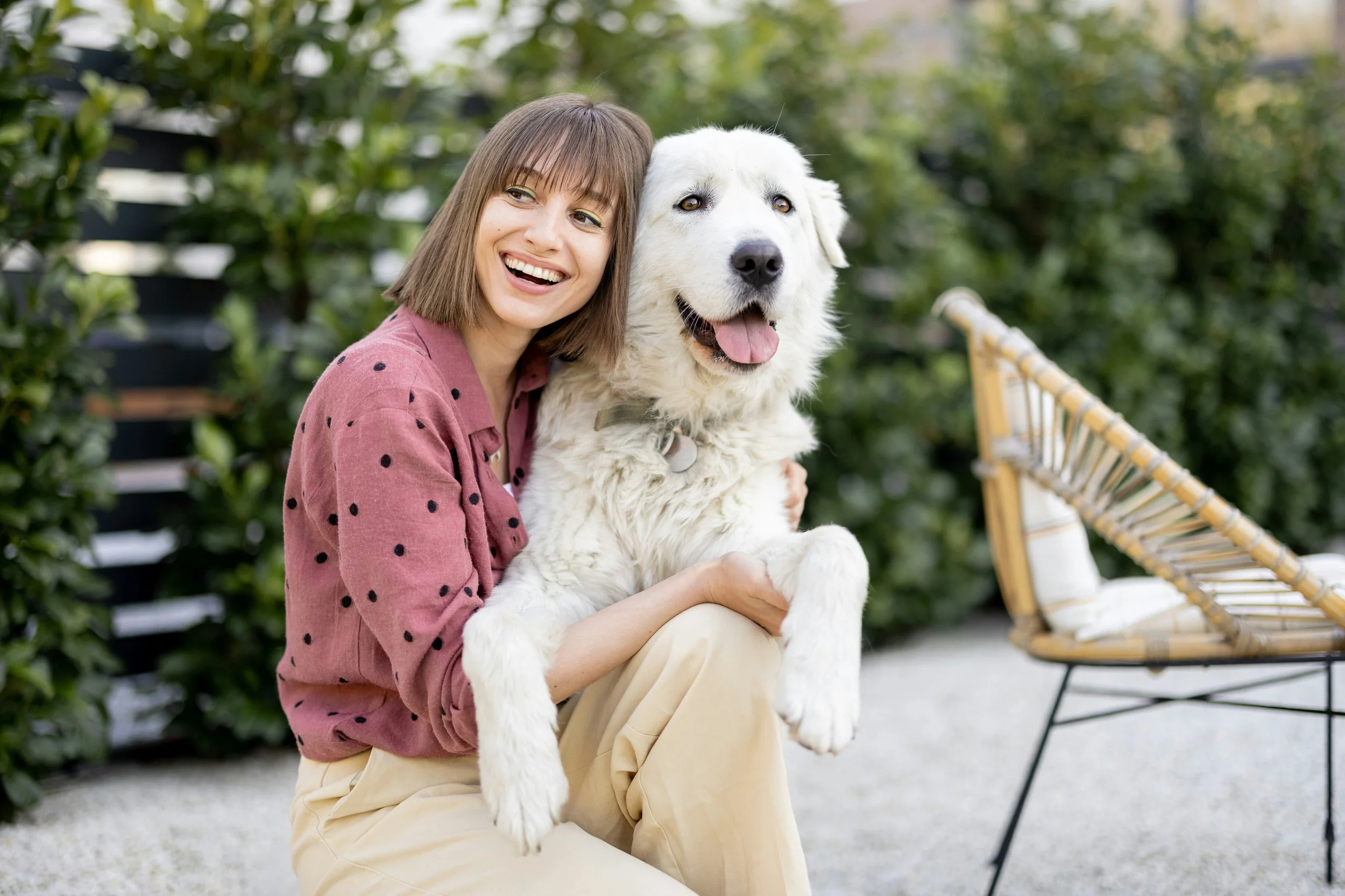 woman holding a big dog