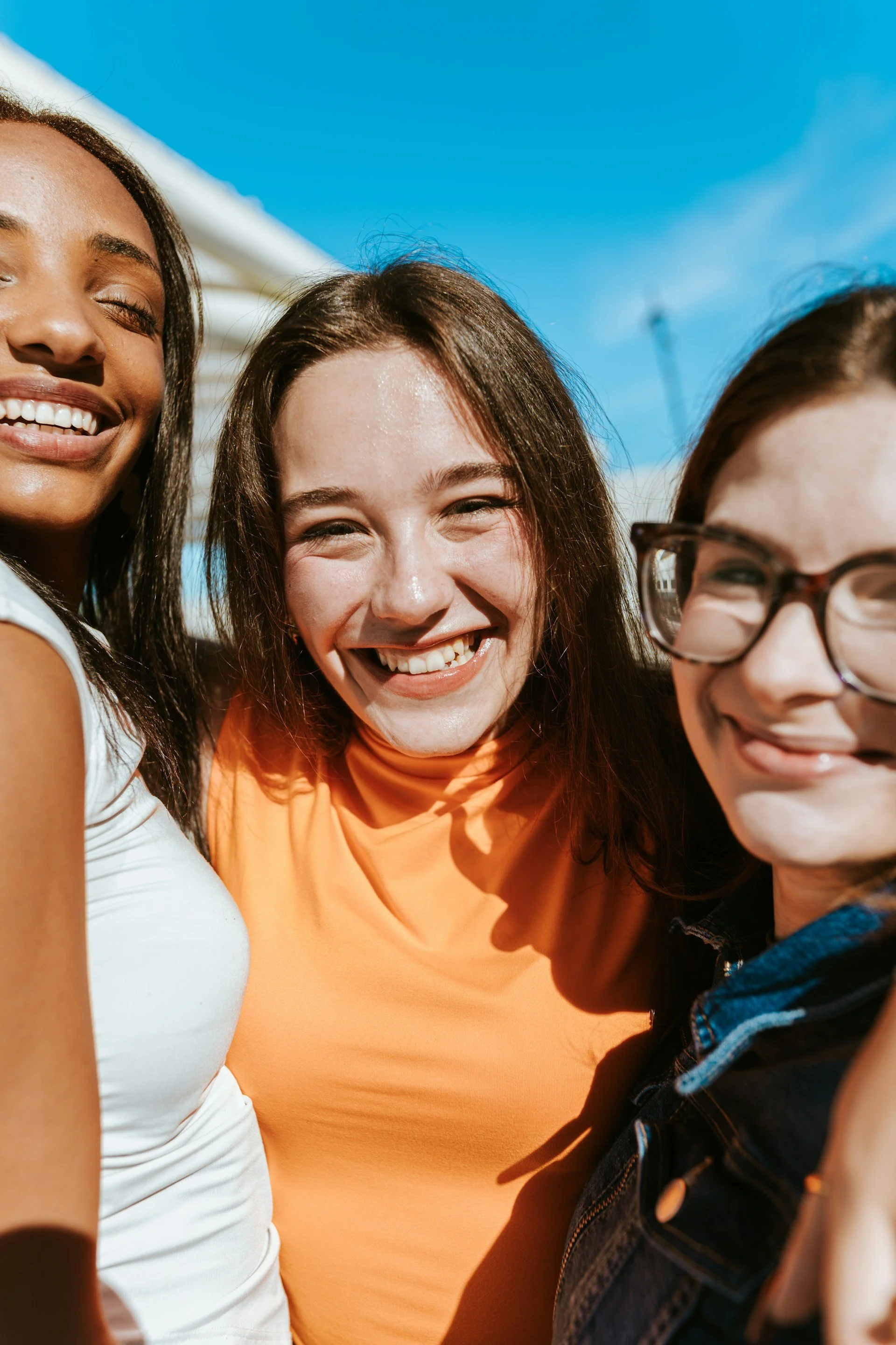 Three women smiling outside after receiving expert CBT therapy at Good Day Mental Health in Ogden along the Wasatch Front