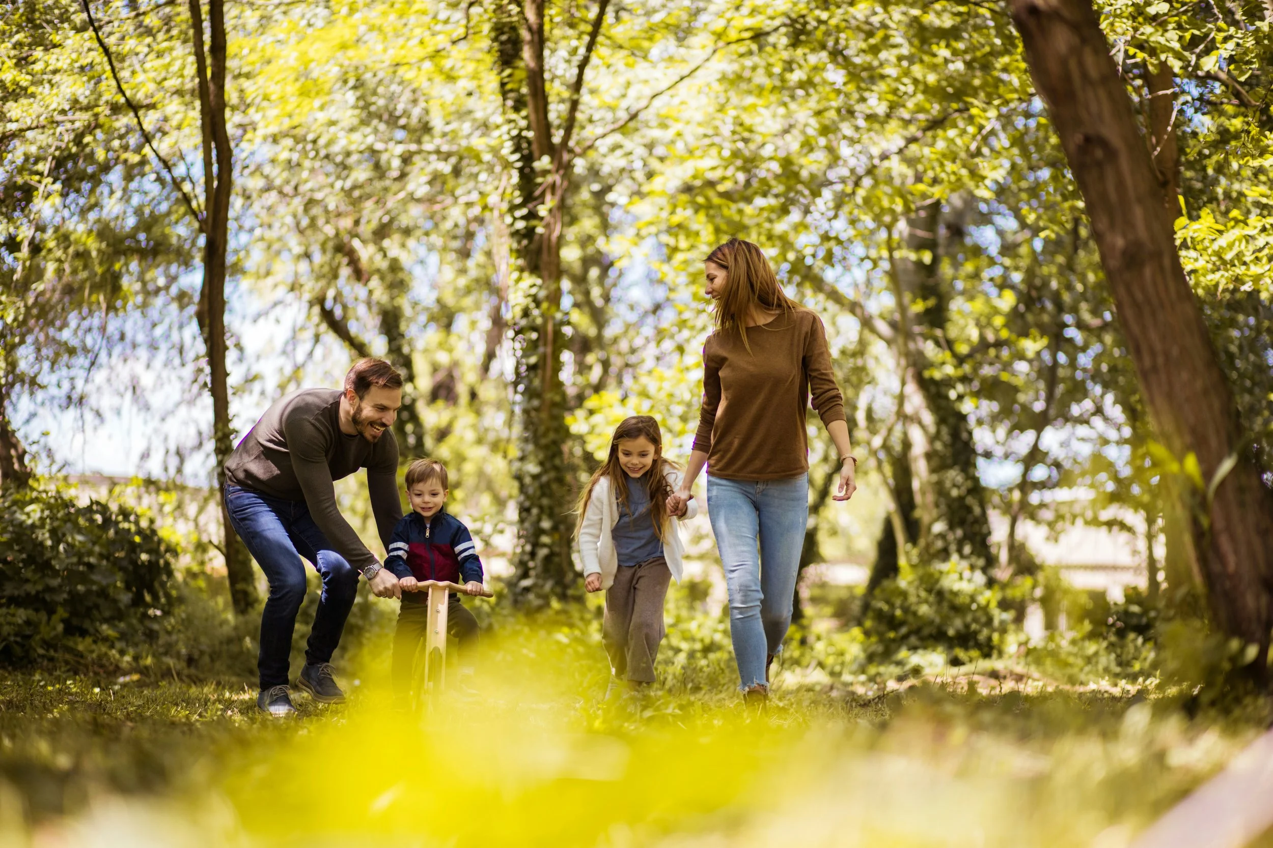 Family walking and riding bikes outdoors representing improved mental health through psychiatry care in Ogden Utah
