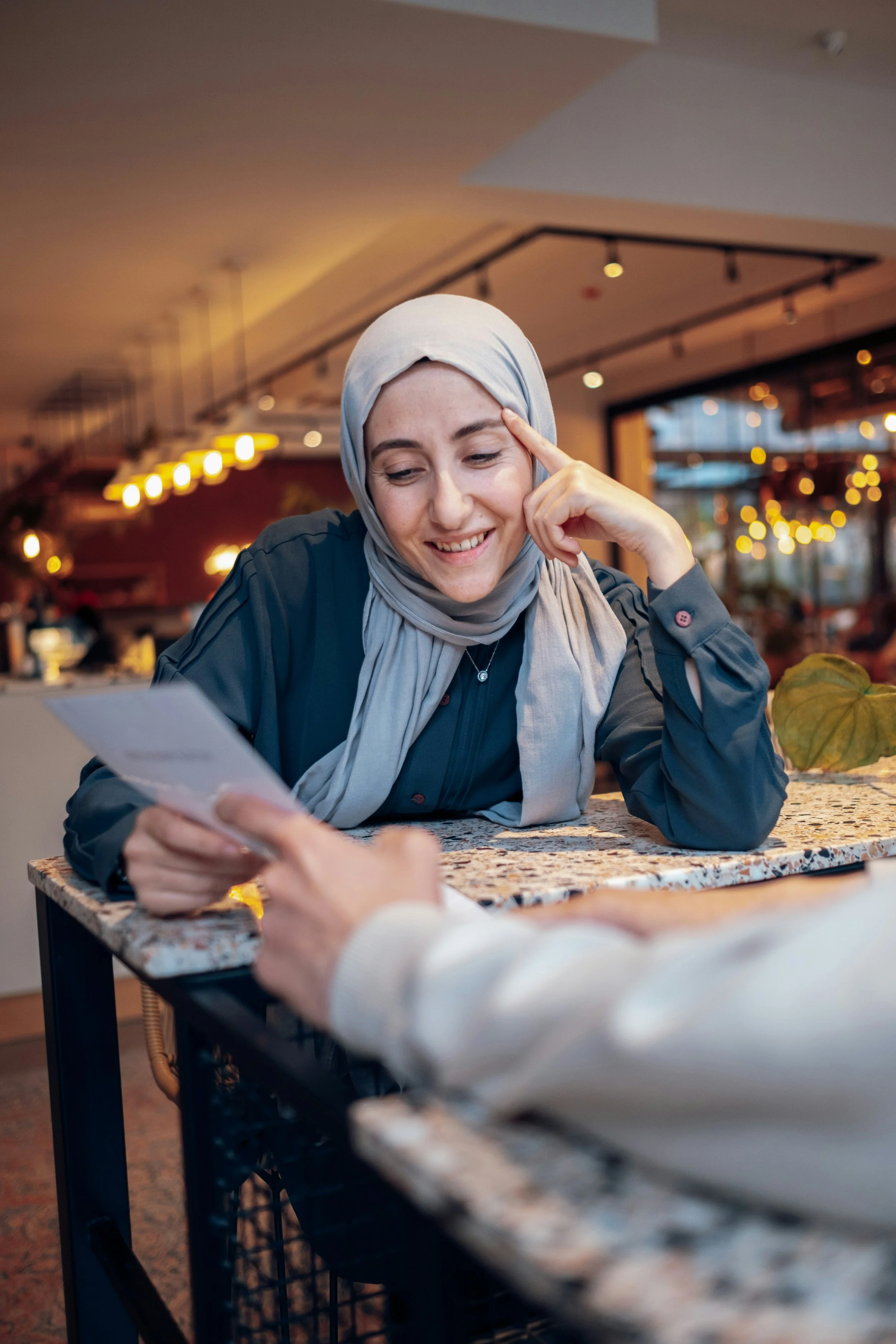 woman reading a menu and smiling